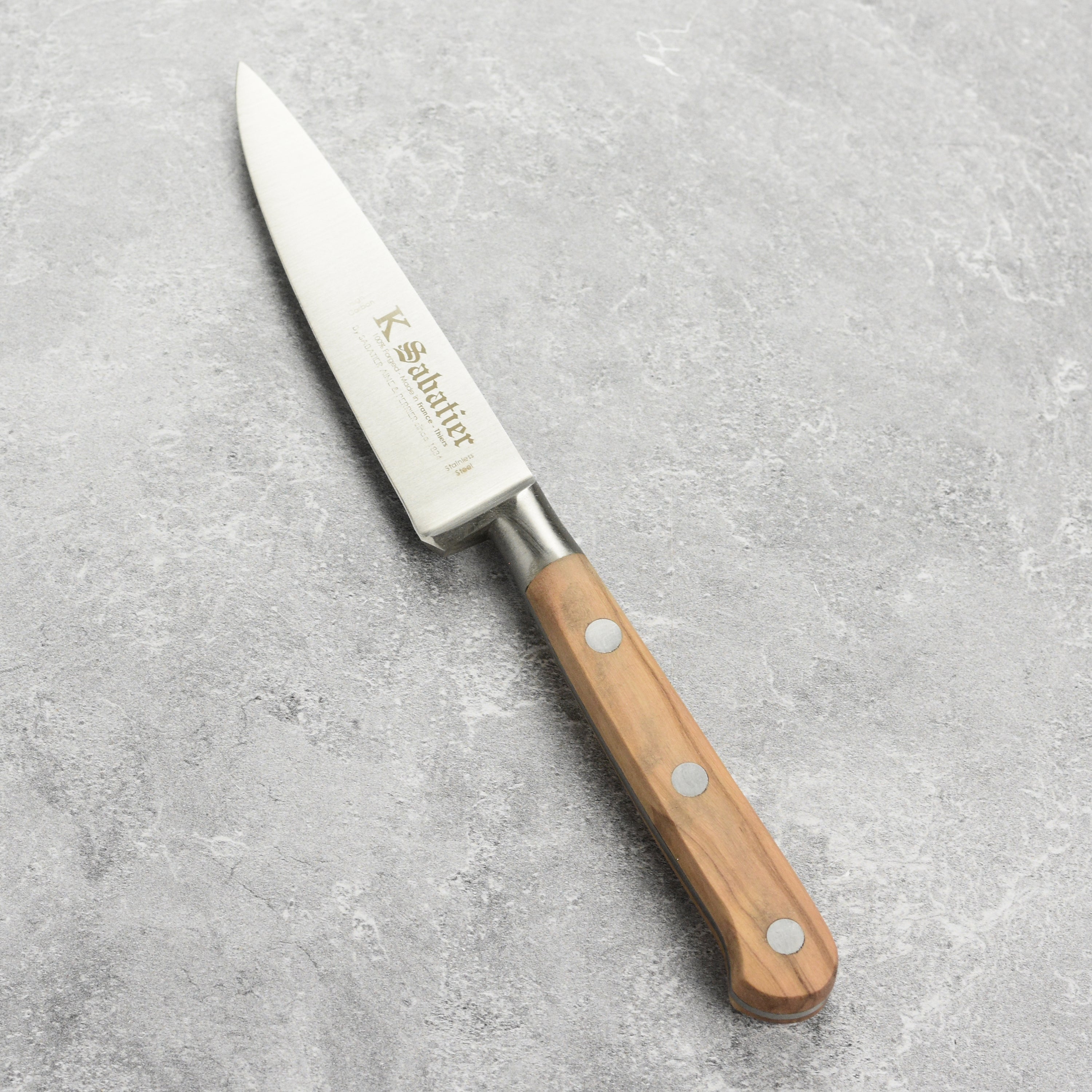 The premium olive wood paring knife in action, demonstrating its precision during food preparation.