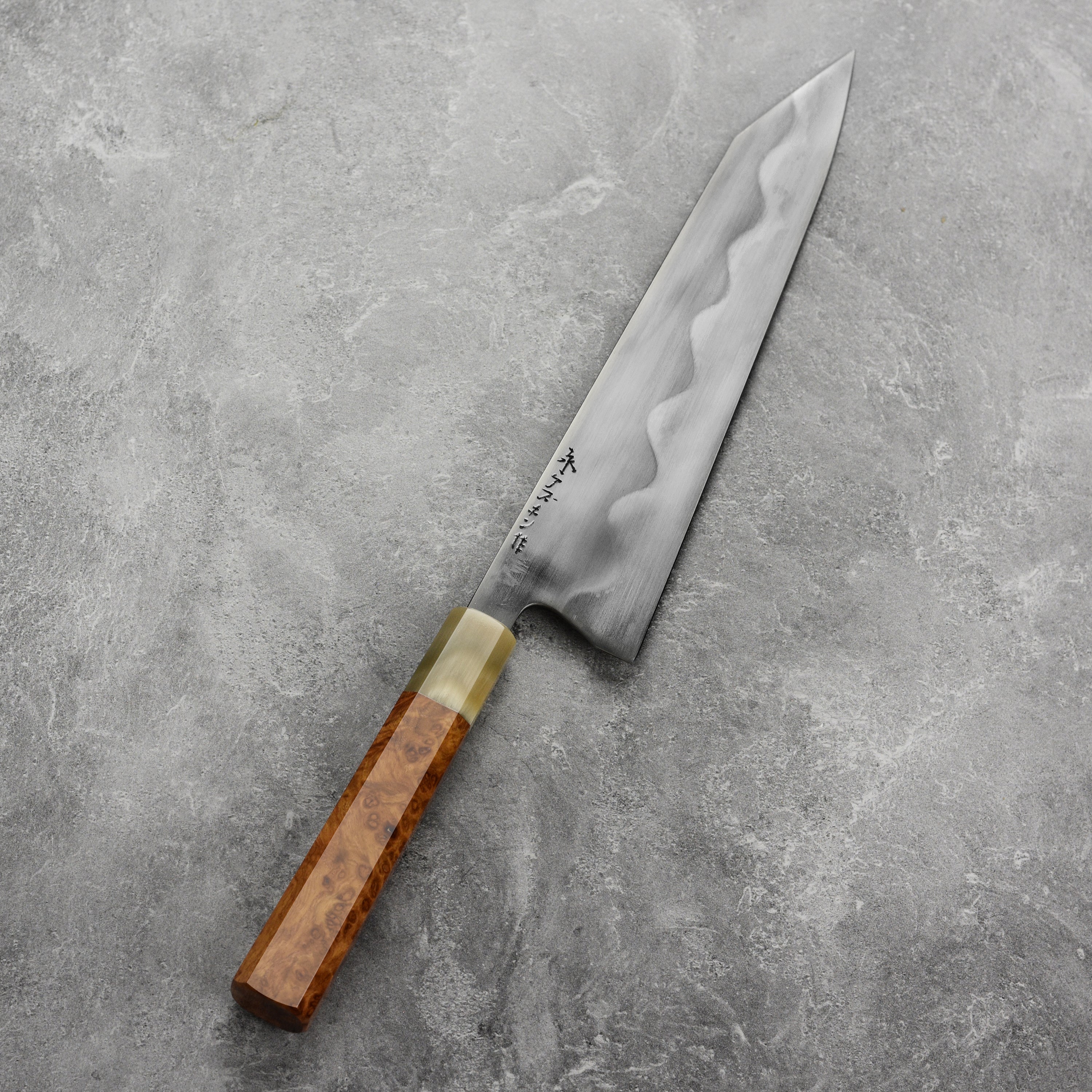 Keskin 9-inch Japanese chef knife with saya, angled view highlighting the blades sharpness