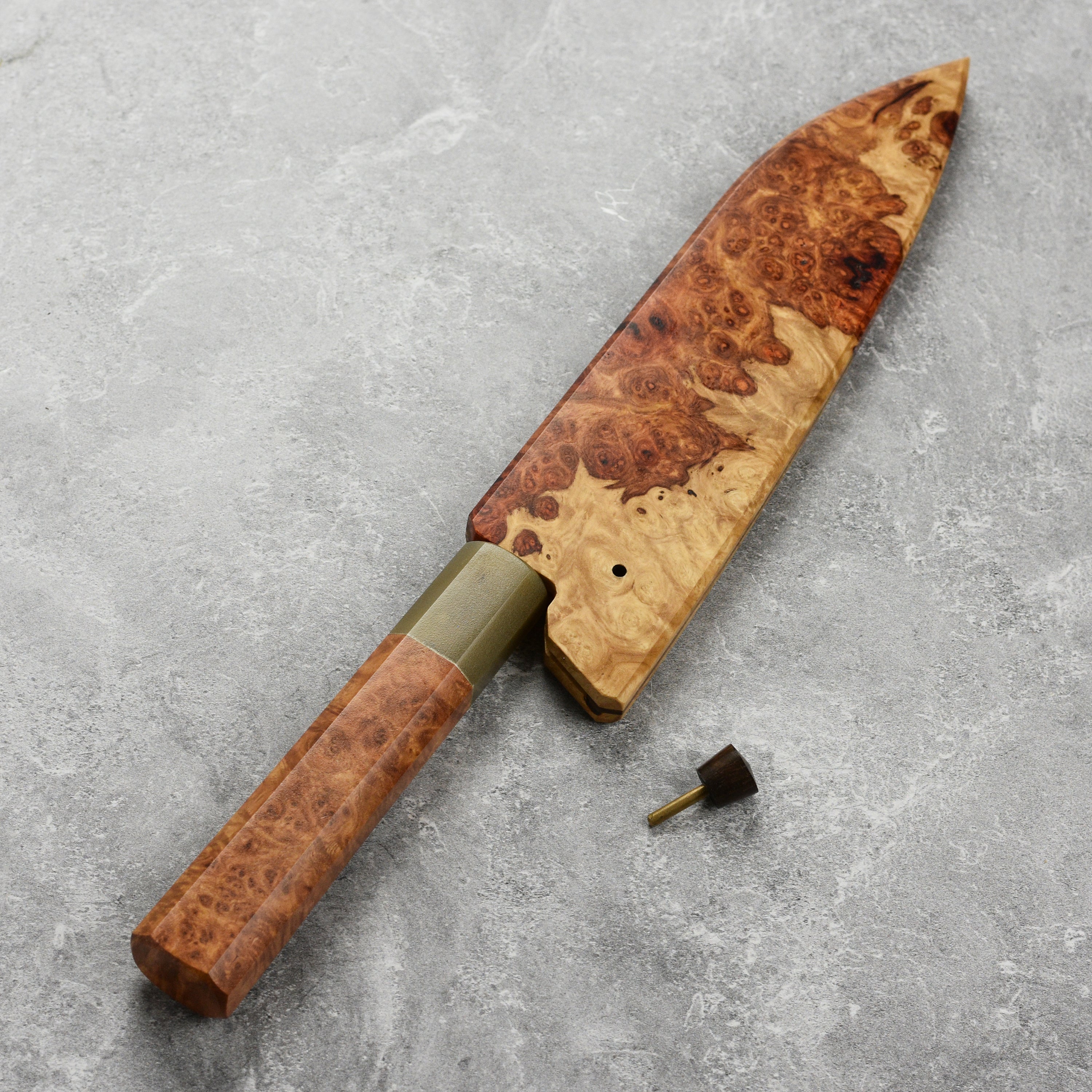Affordable carbon steel utility knife displayed with its protective saya, emphasizing craftsmanship.