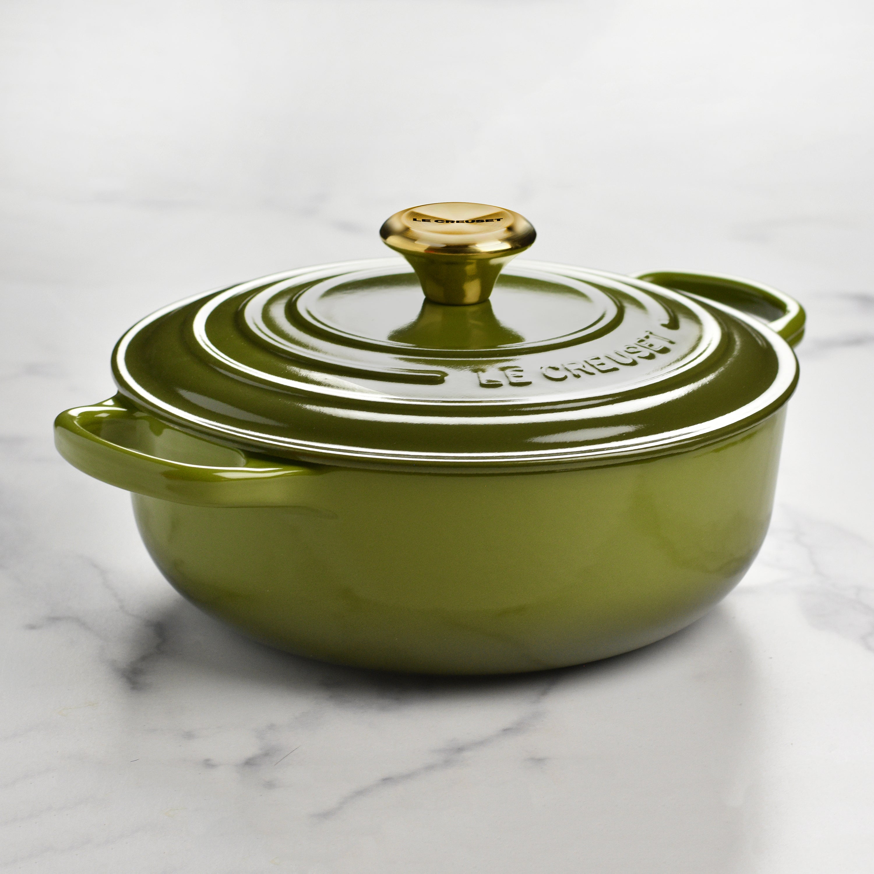 Le Creuset sauteuse on a stove, demonstrating compatibility with various cooktops