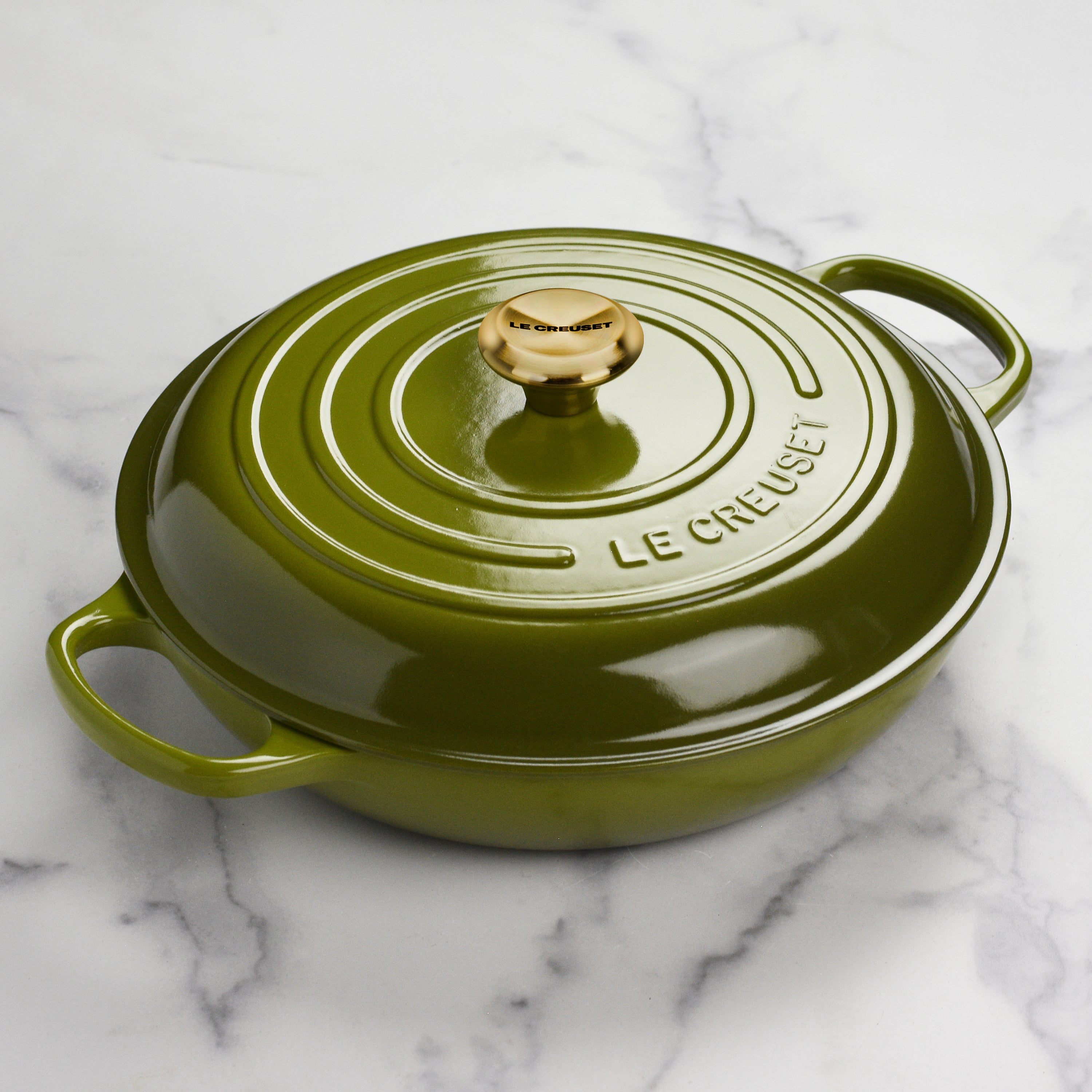 Le Creuset cast iron braiser used for slow cooking in a modern kitchen setting