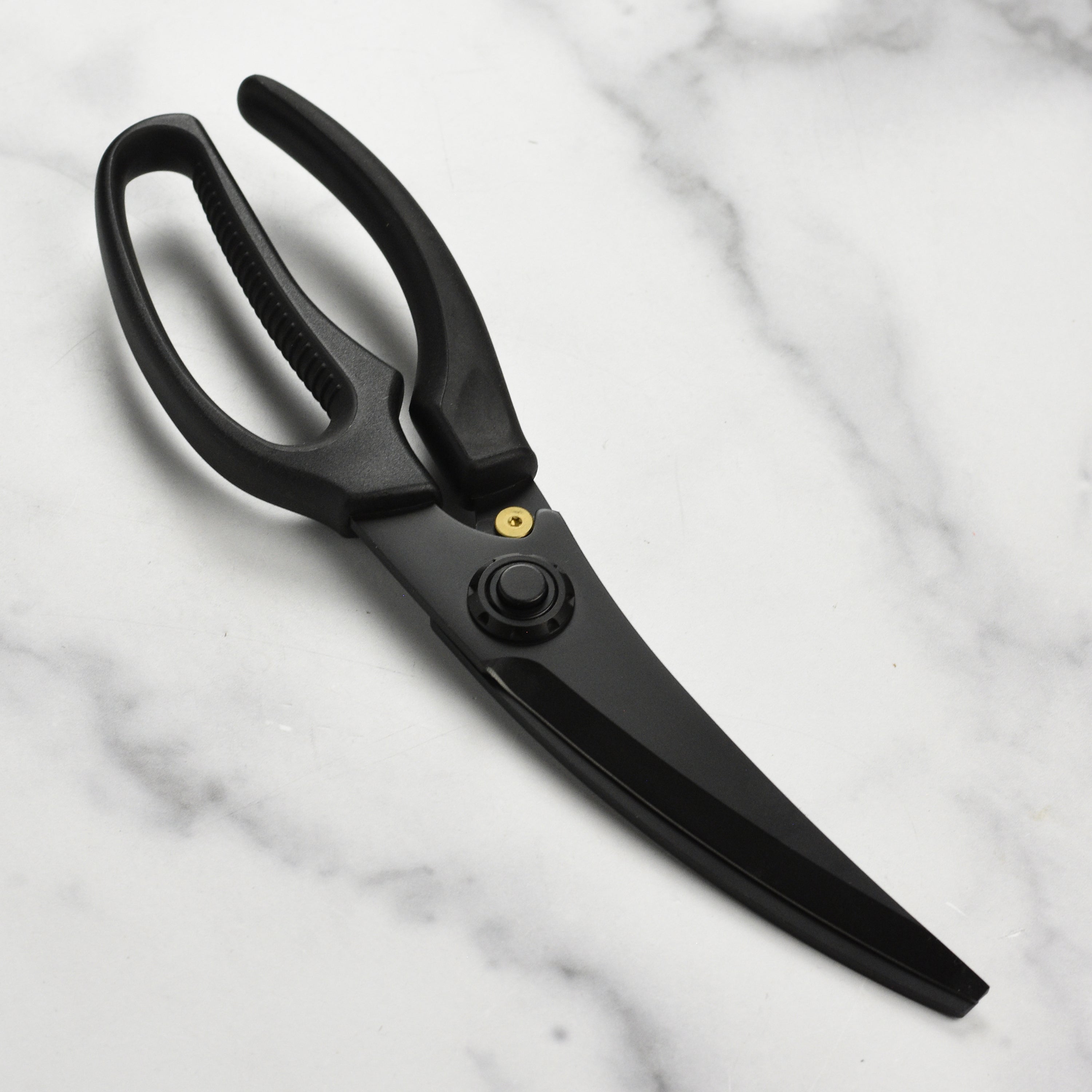 Close-up of the Titanium Pro Poultry Shears demonstrating the push button release feature.