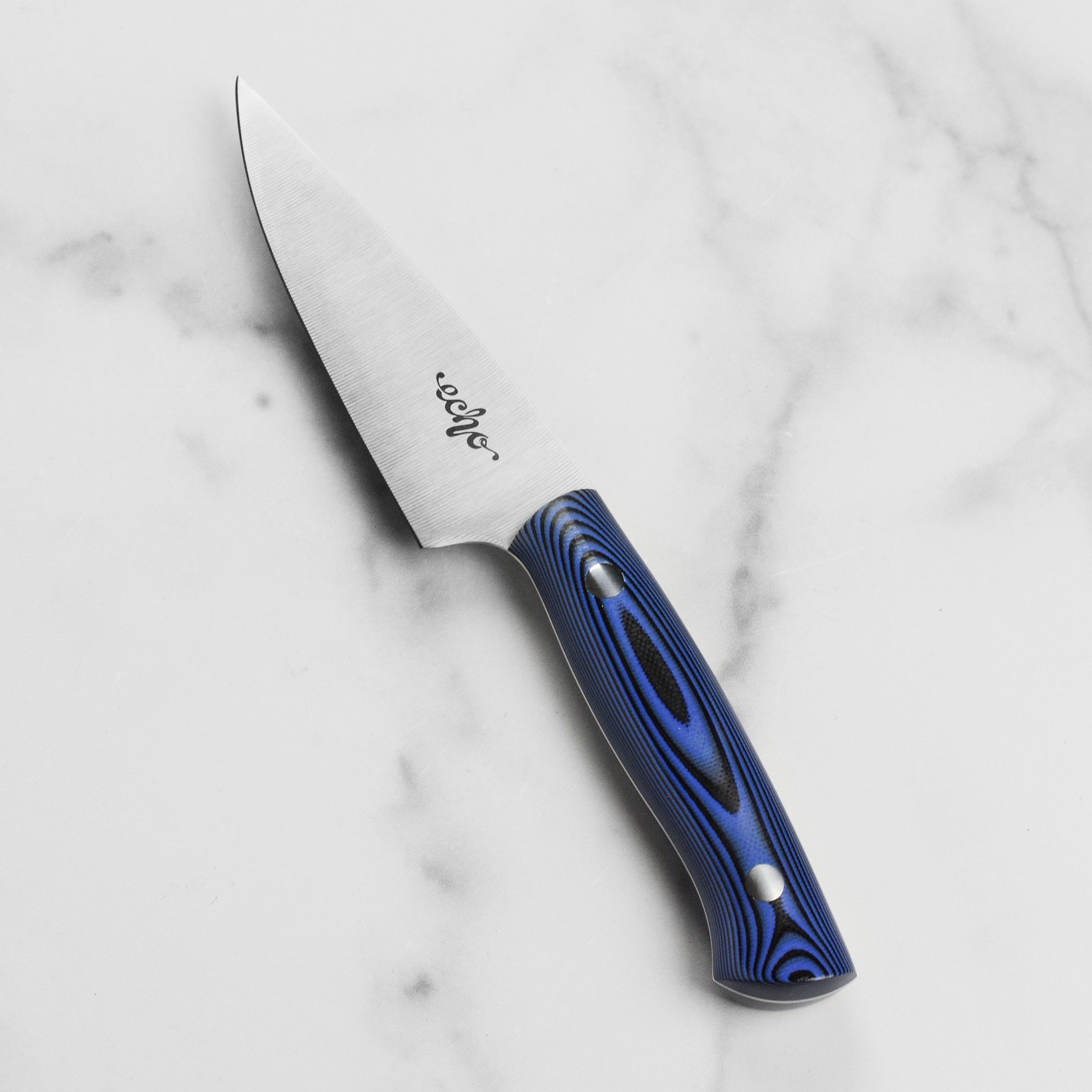 Hand holding Middleton Echo paring knife for detailed food prep
