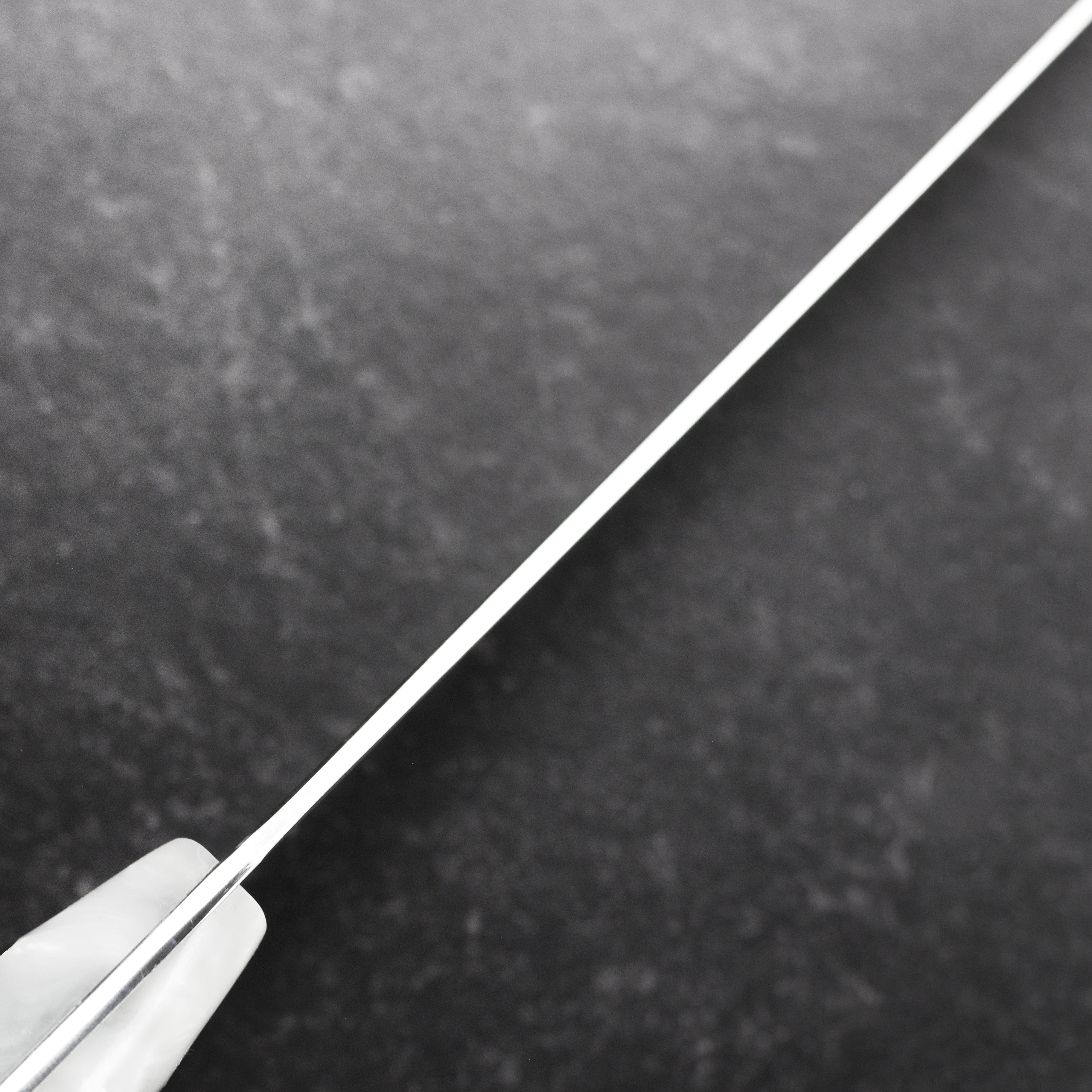 Close-up of the blades edge and Cerakote coating on Middleton Pearl Echo chefs knife