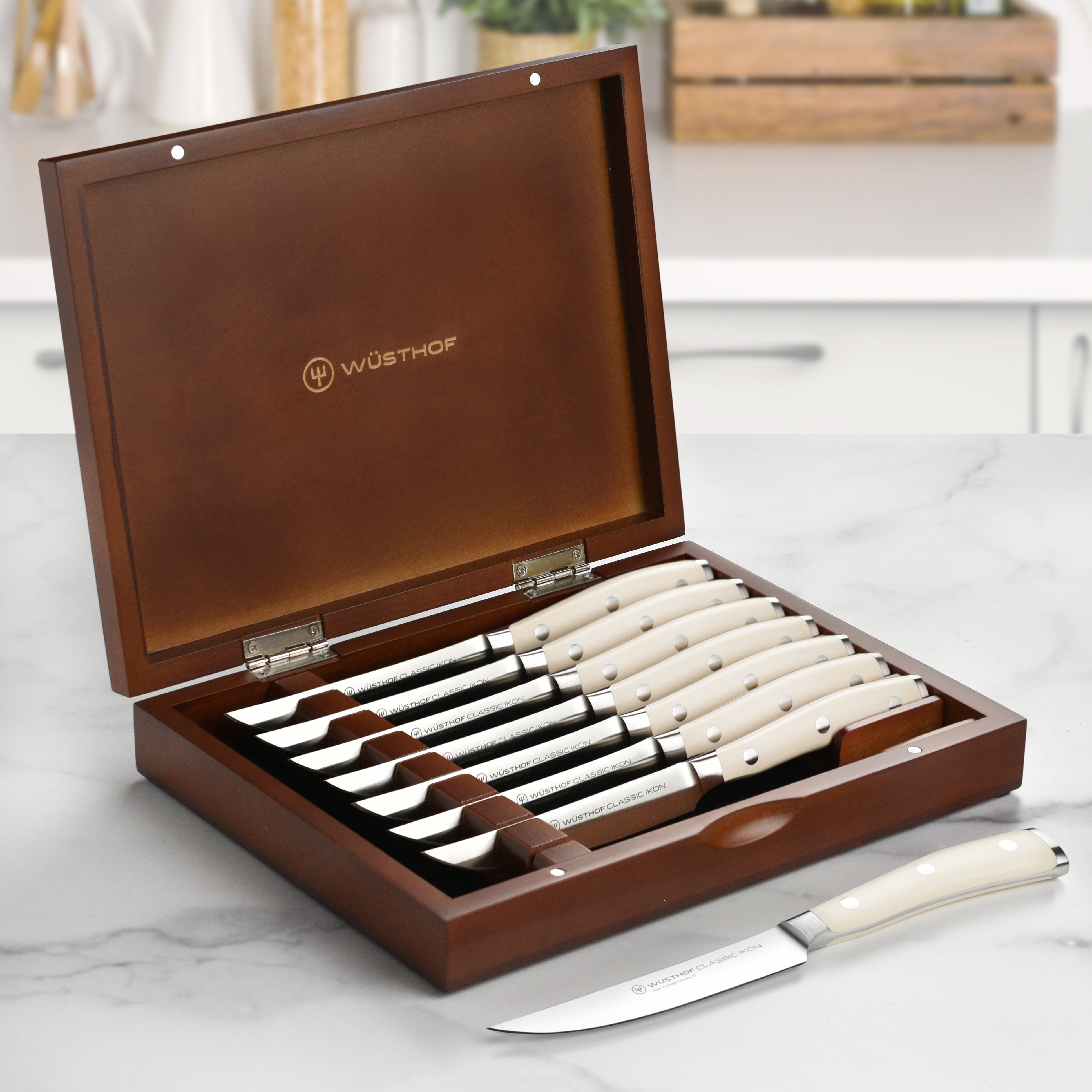 Wusthof Classic Ikon steak knife set displayed in elegant wood case from the side