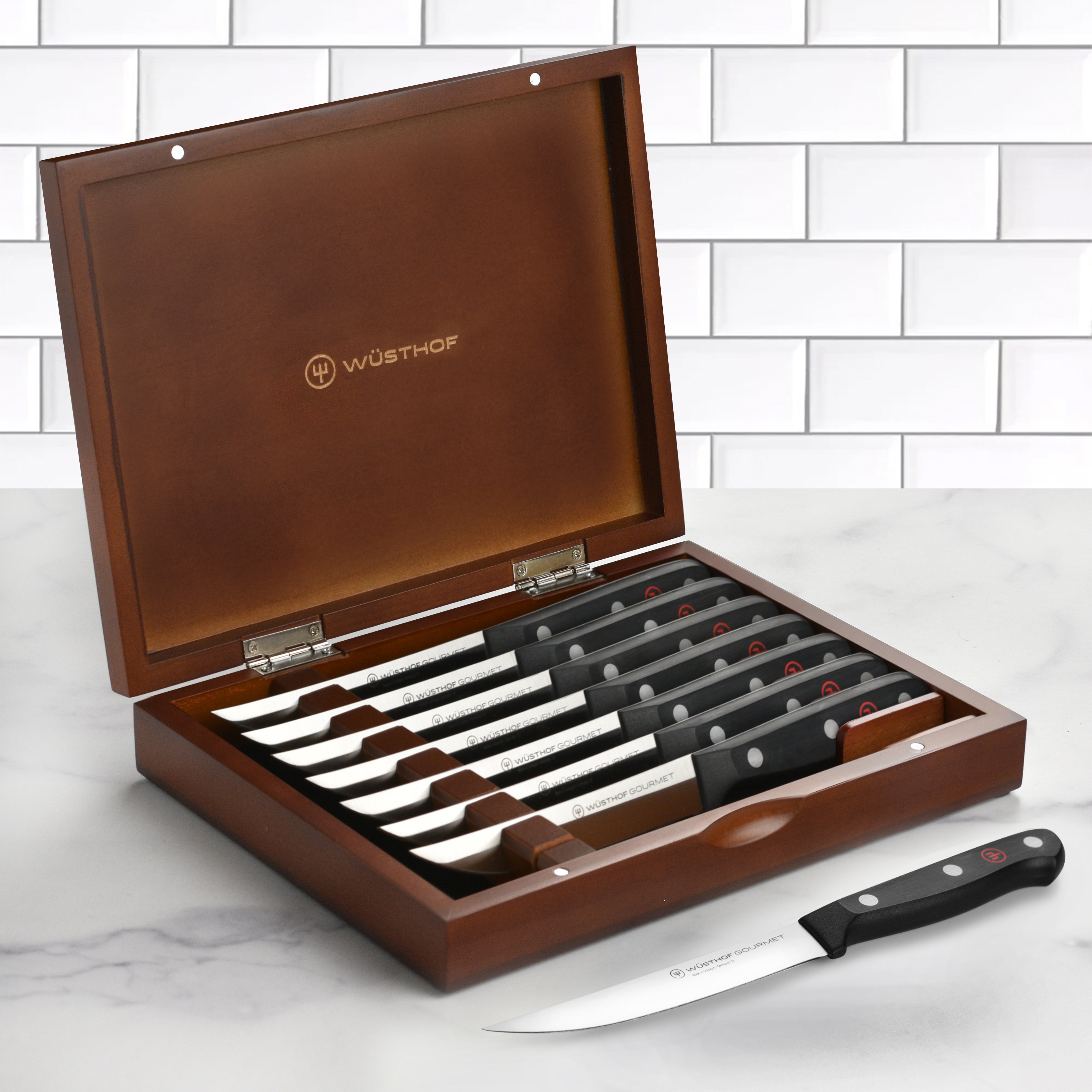 Wusthof Gourmet 8-piece steak knife set with case on a kitchen counter
