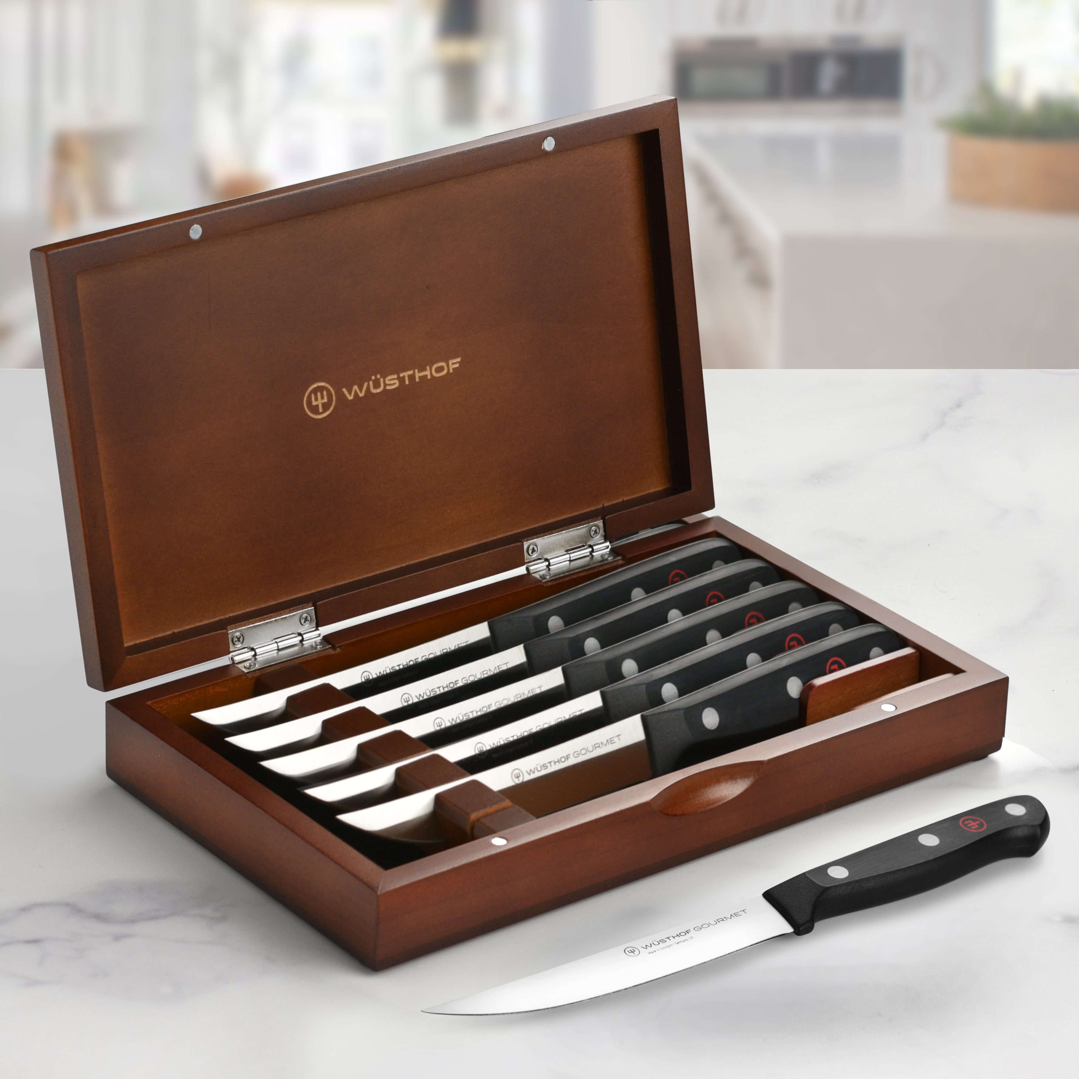 Close-up of Wusthof gourmet steak knives highlighting the precision blade and ergonomic handle.