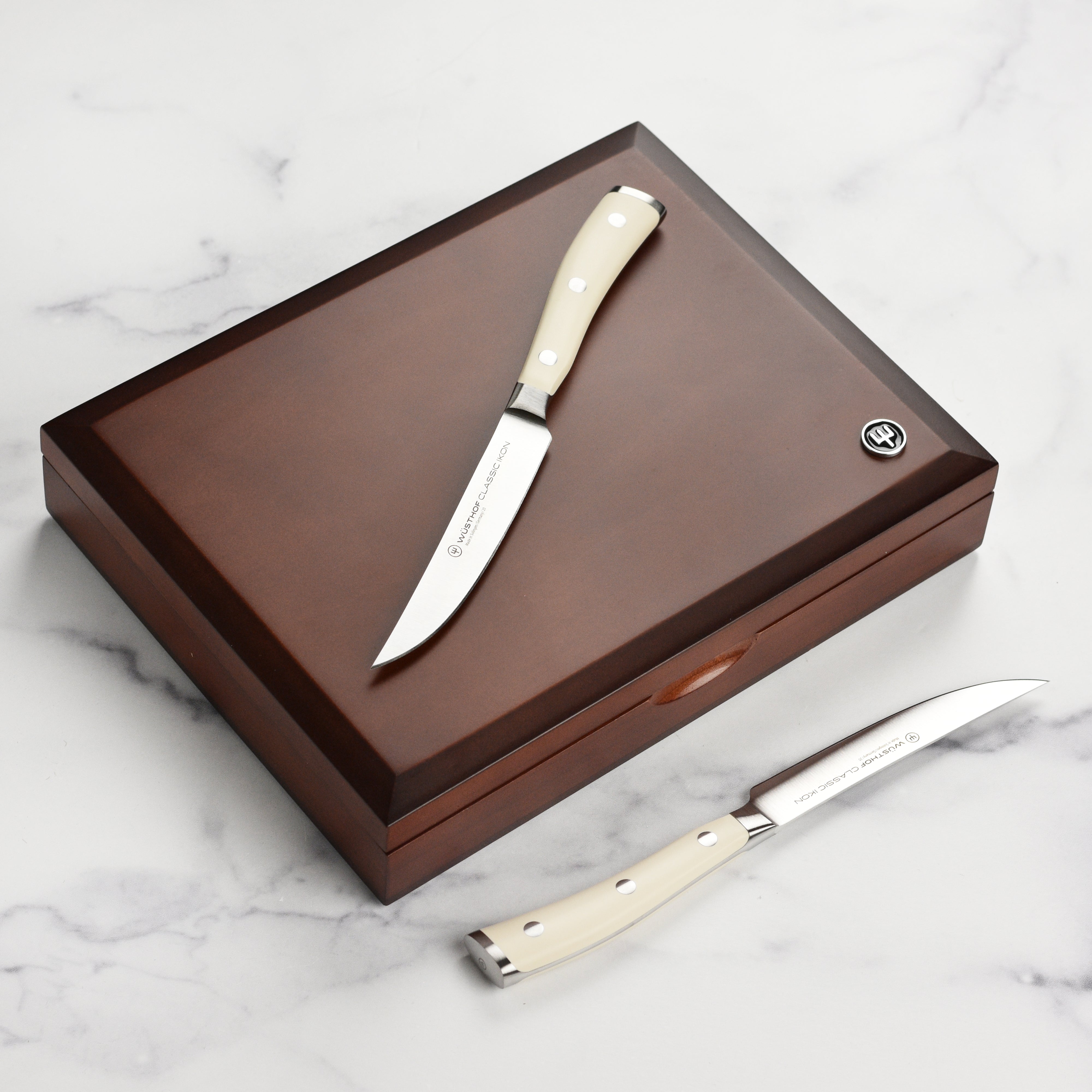 Close-up of Wusthof steak knives highlighting the precision blade and creme handle