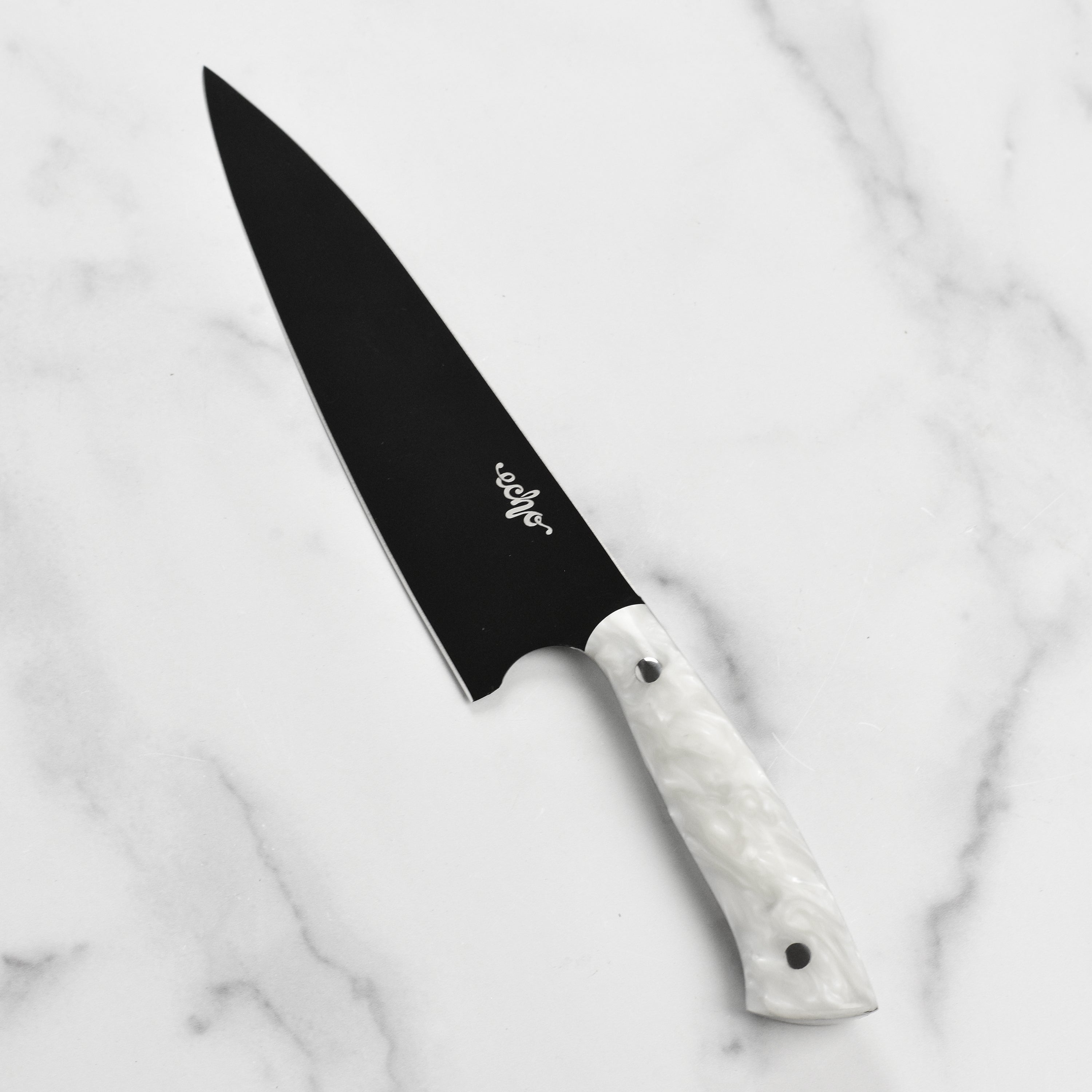 Close-up of the blades edge and Cerakote coating on Middleton Pearl Echo chefs knife