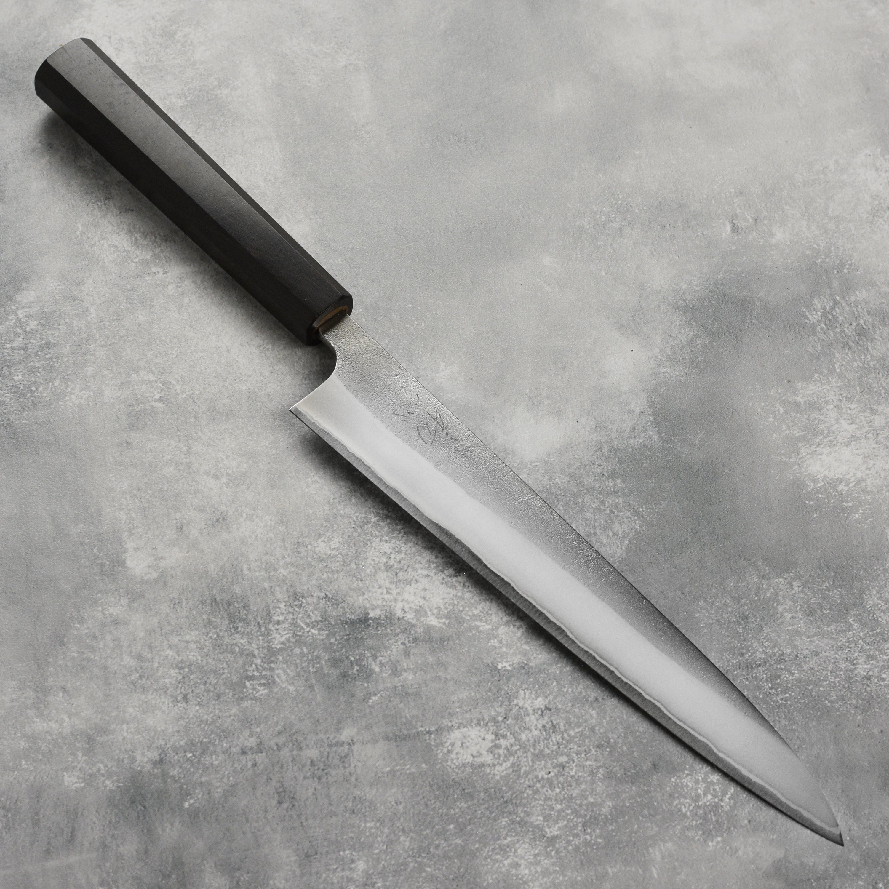 Yoshikane Shirogami #2 Nashiji stainless sujihiki knife angled for precision slicing