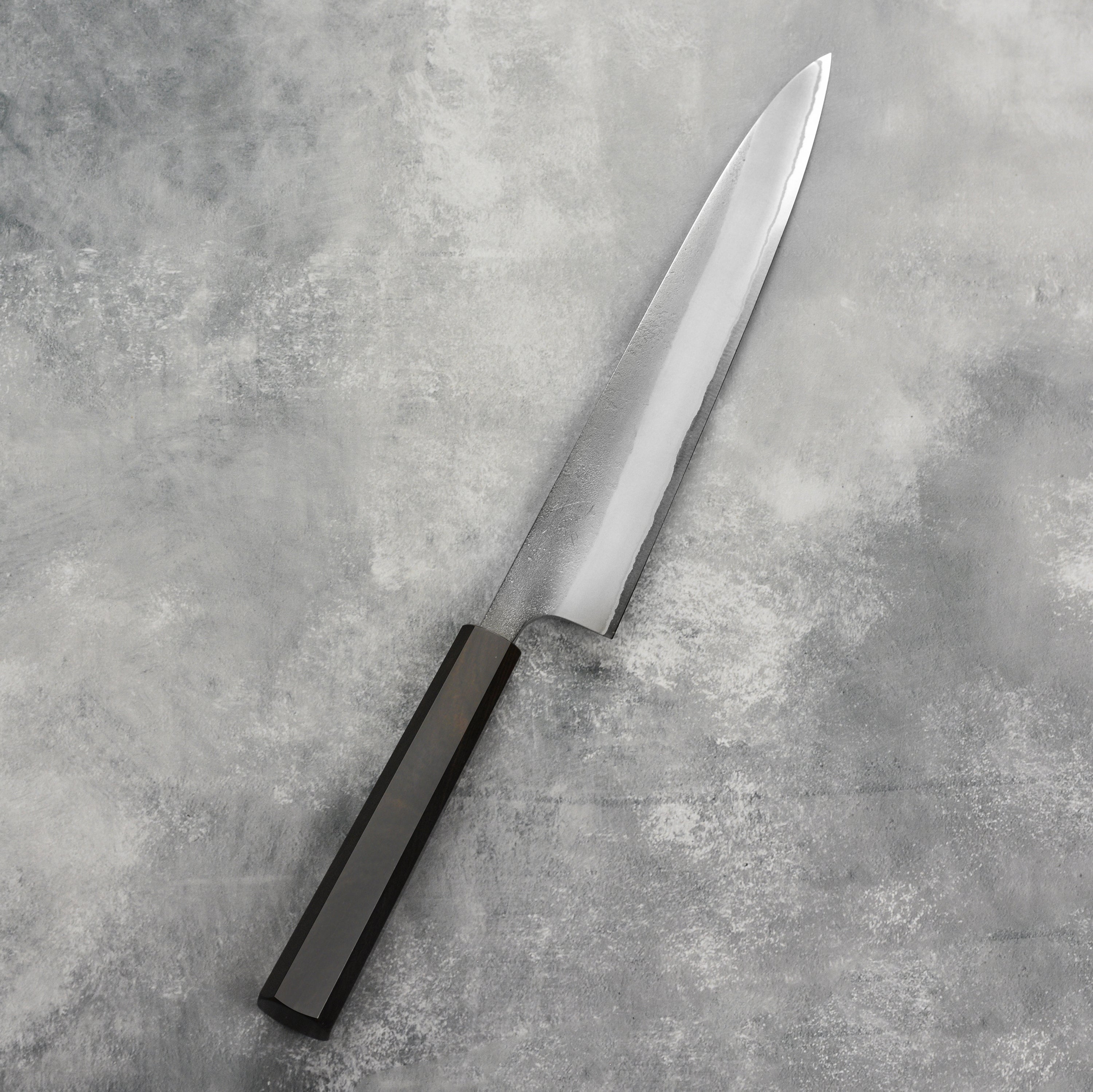 Close-up of the sharp edge and craftsmanship of the Yoshikane sujihiki knife