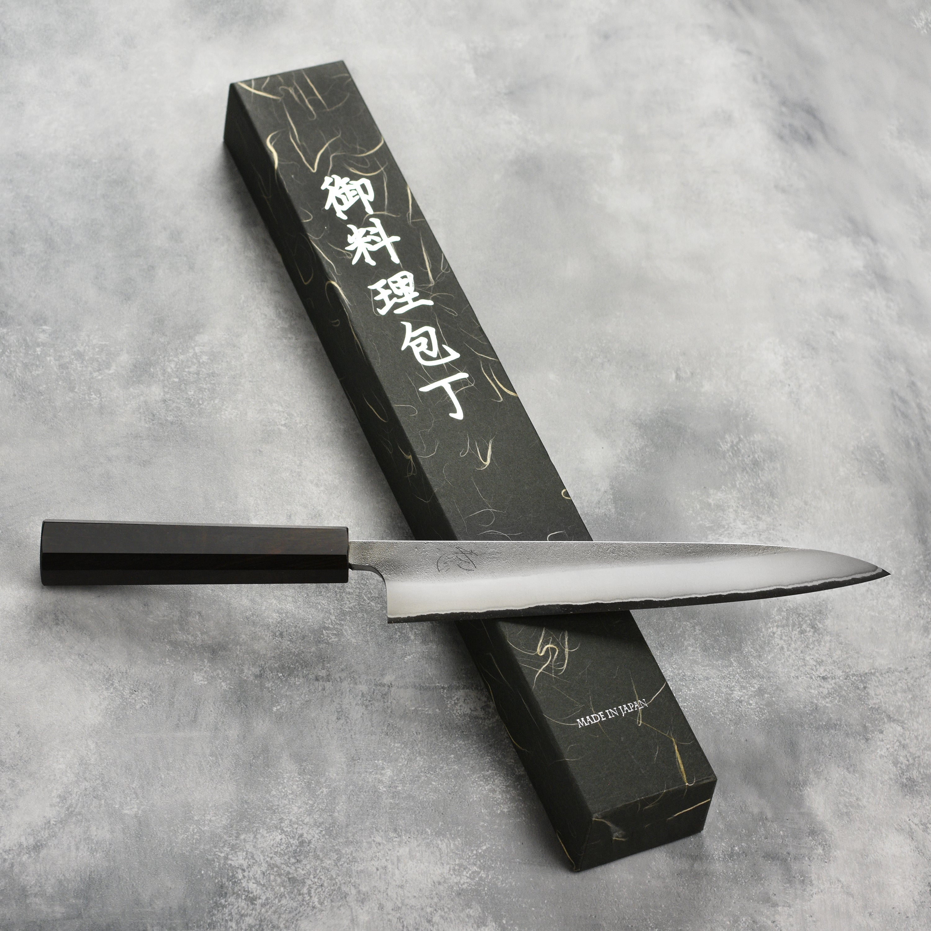 Yoshikane Shirogami #2 Nashiji stainless sujihiki knife angled for precision slicing