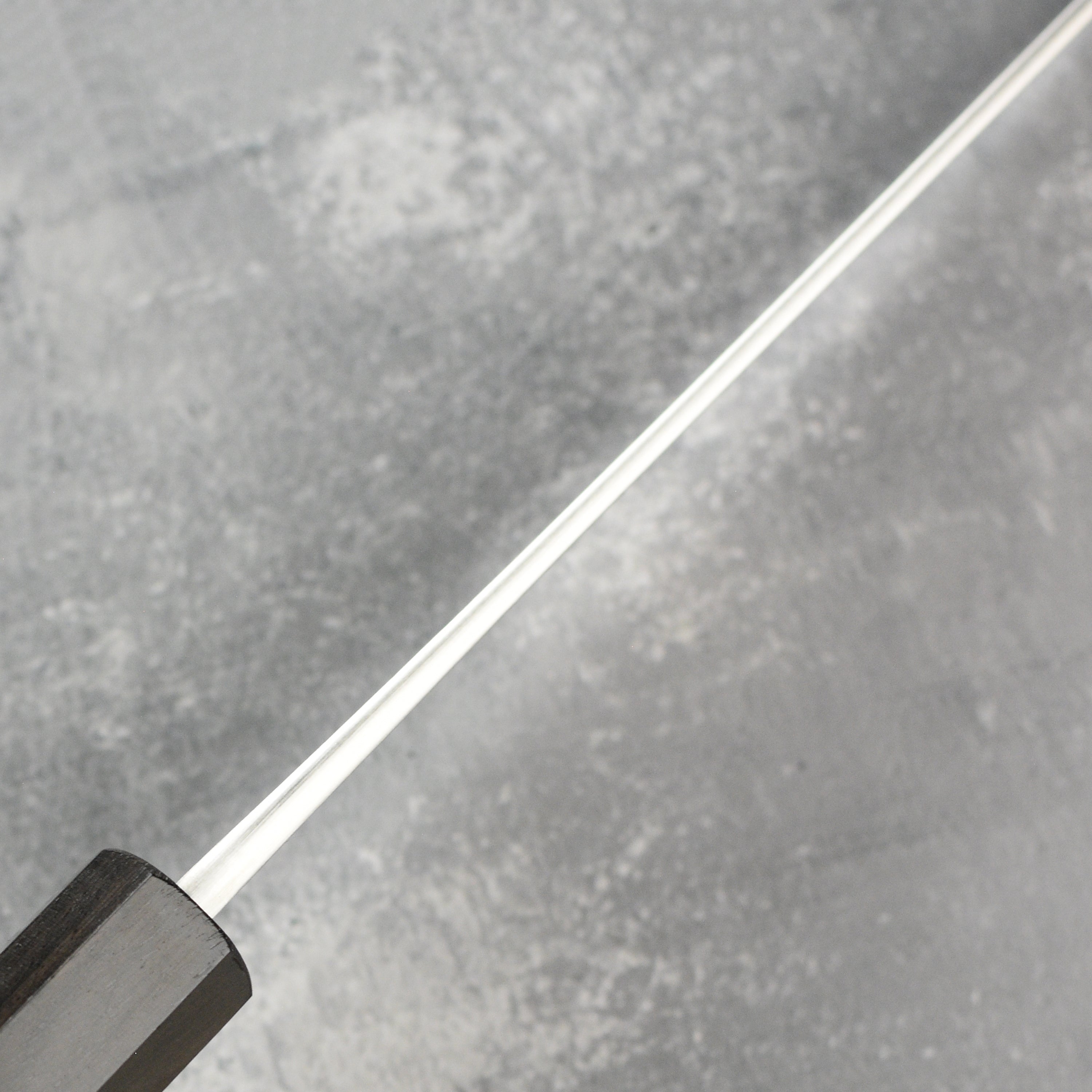 Close-up of the sharp edge and craftsmanship of the Yoshikane sujihiki knife