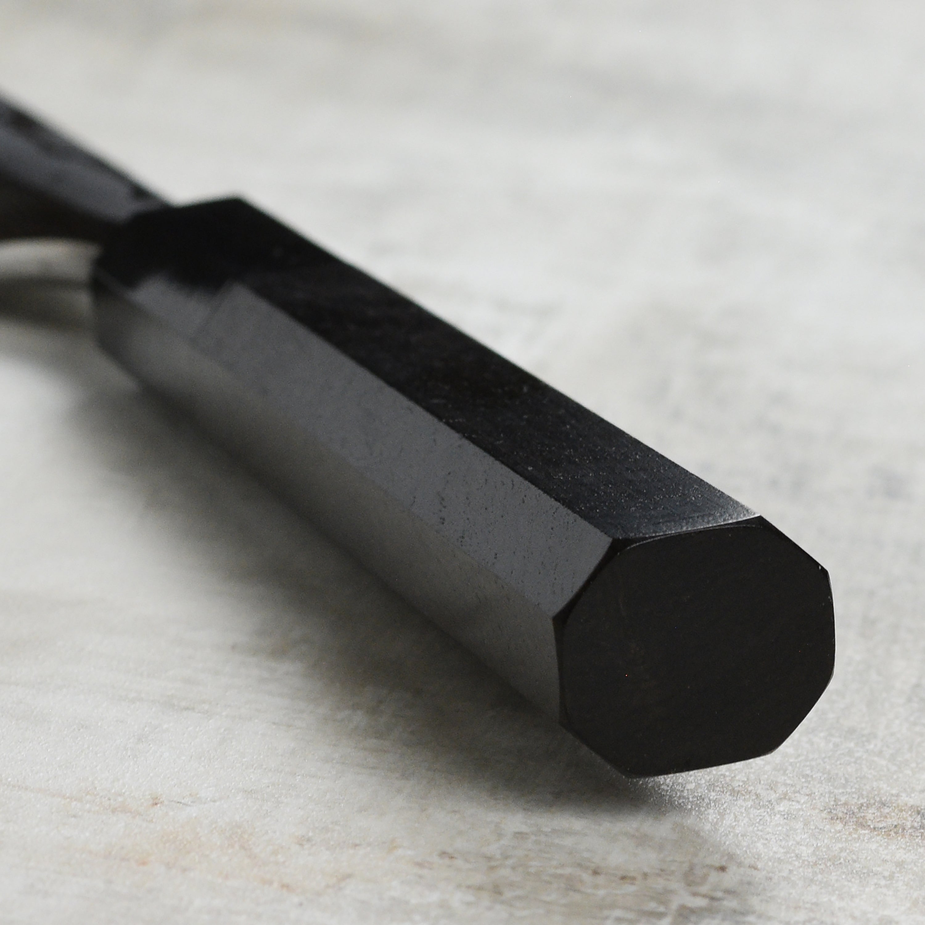 Close-up of the blade of the Hatsukokoro Damascus knife, highlighting its single bevel design and craftsmanship.