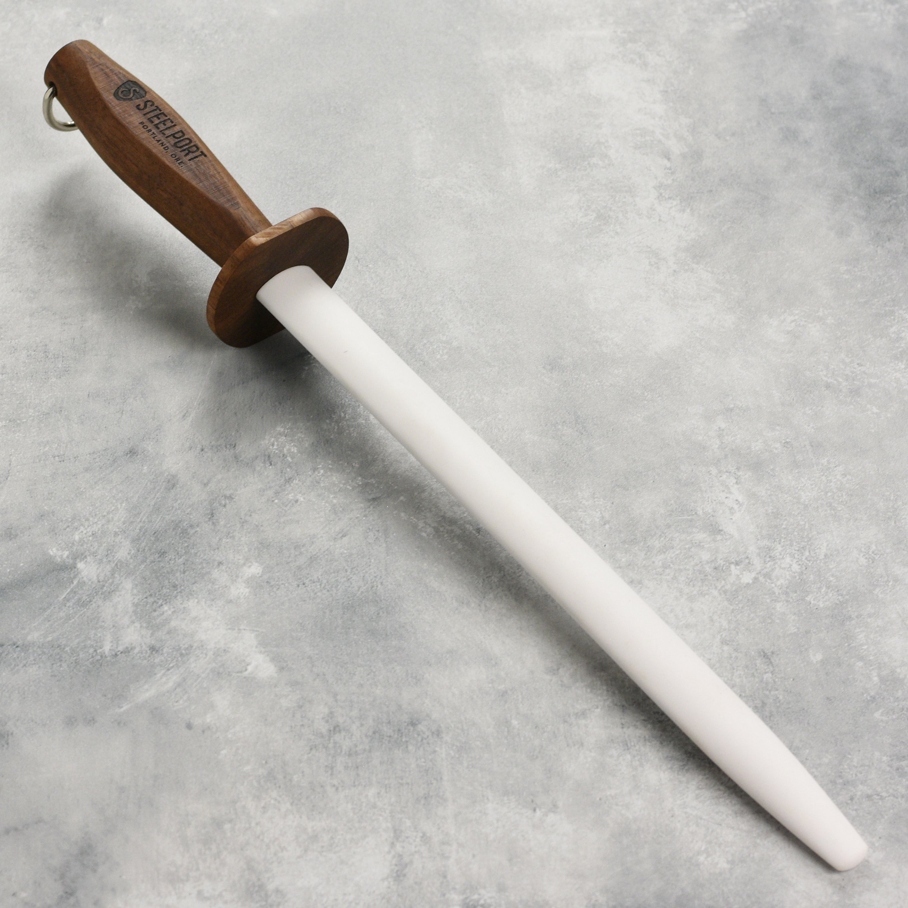 Close-up of the Steelport ceramic honing rod showcasing its oval shape and ceramic surface.