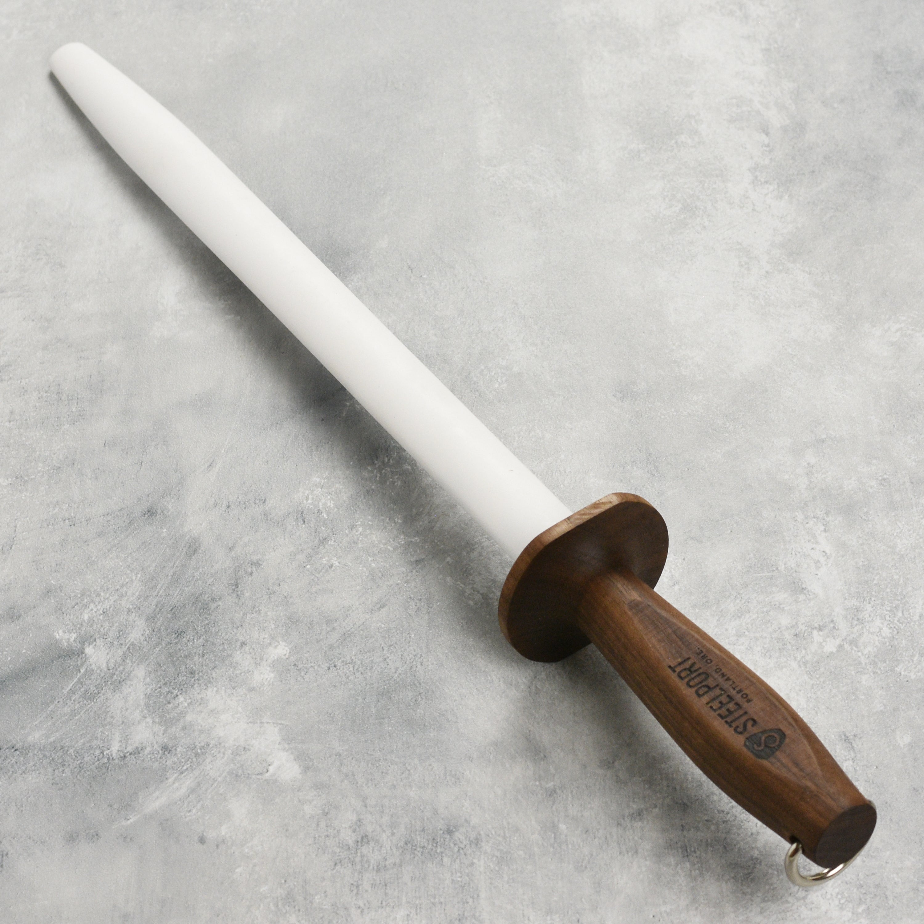 Detailed view of the walnut wood handle and steel core of the Steelport honing rod.