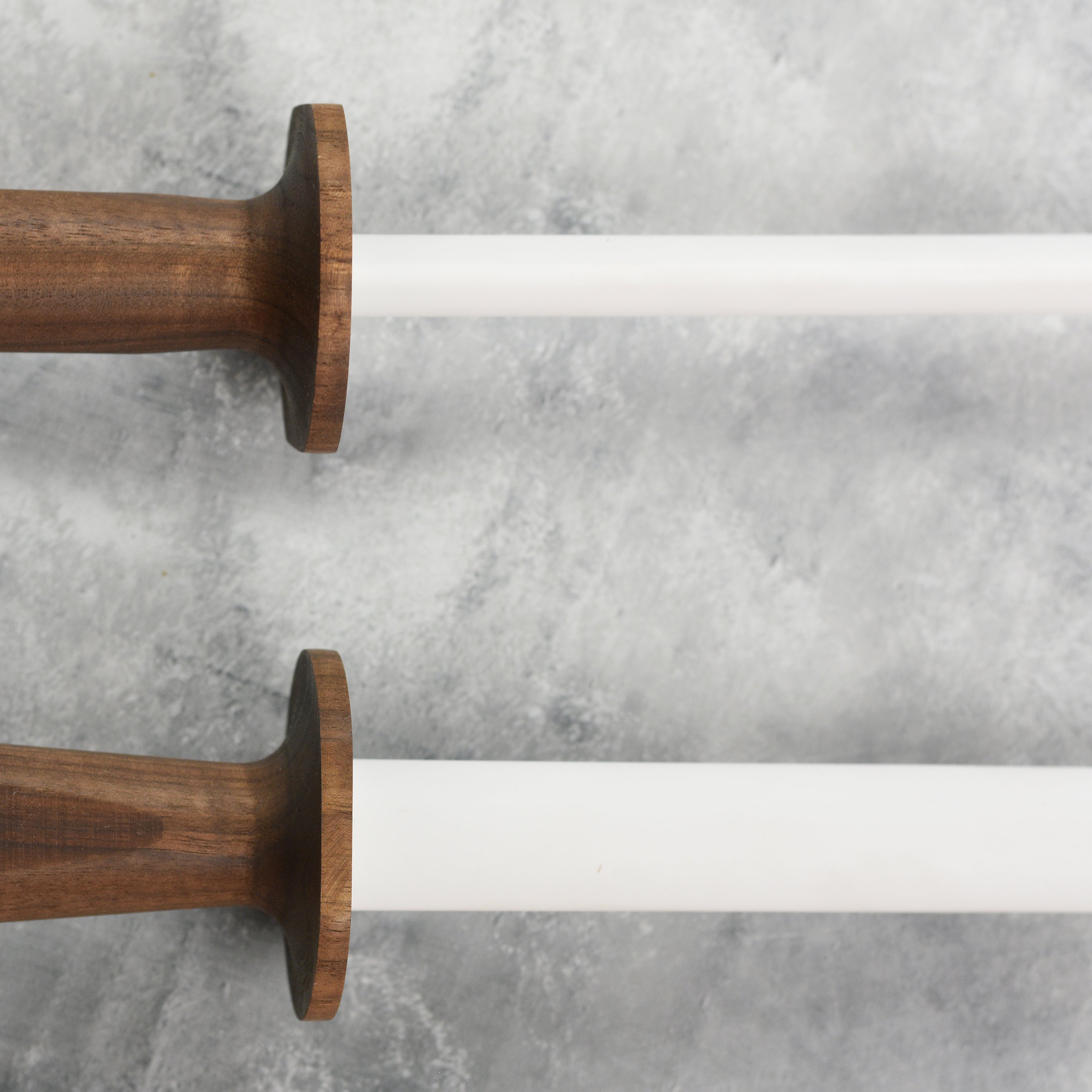 Detailed view of the walnut wood handle and steel core of the Steelport honing rod.