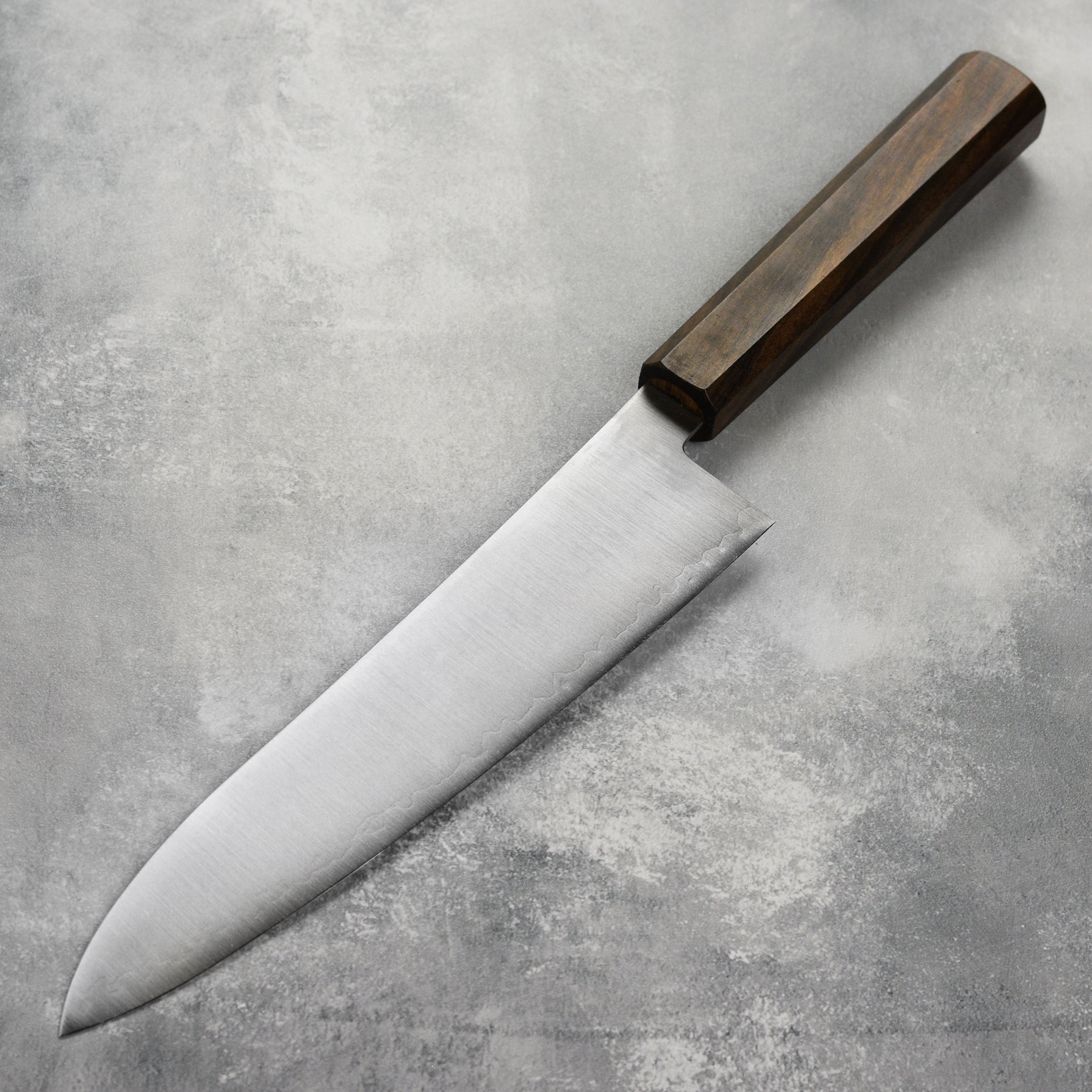 Hatsukokoro Hayabusa Gyuto knife in action, slicing fresh vegetables effortlessly.