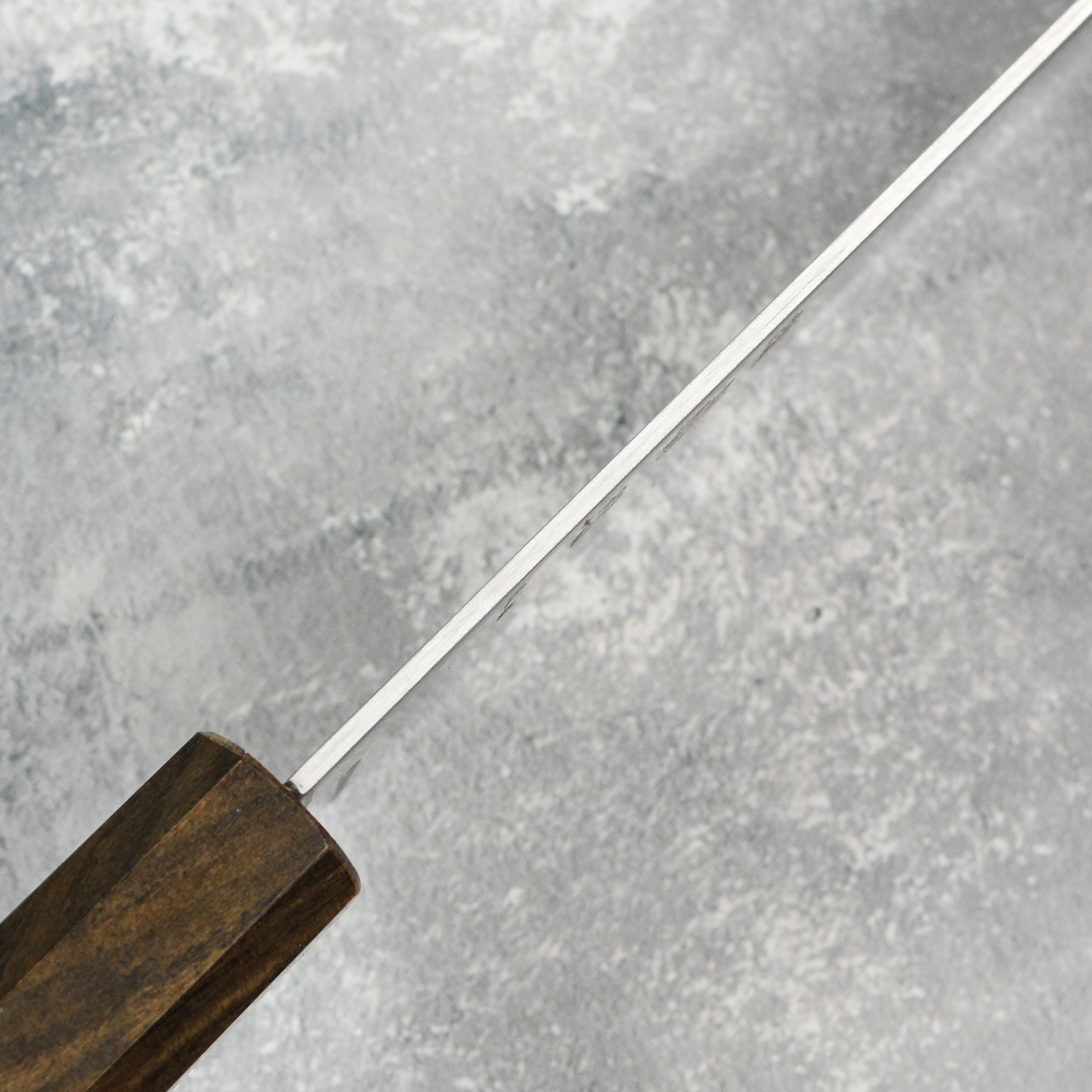 Hatsukokoro Hayabusa Gyuto knife in action, slicing fresh vegetables effortlessly.