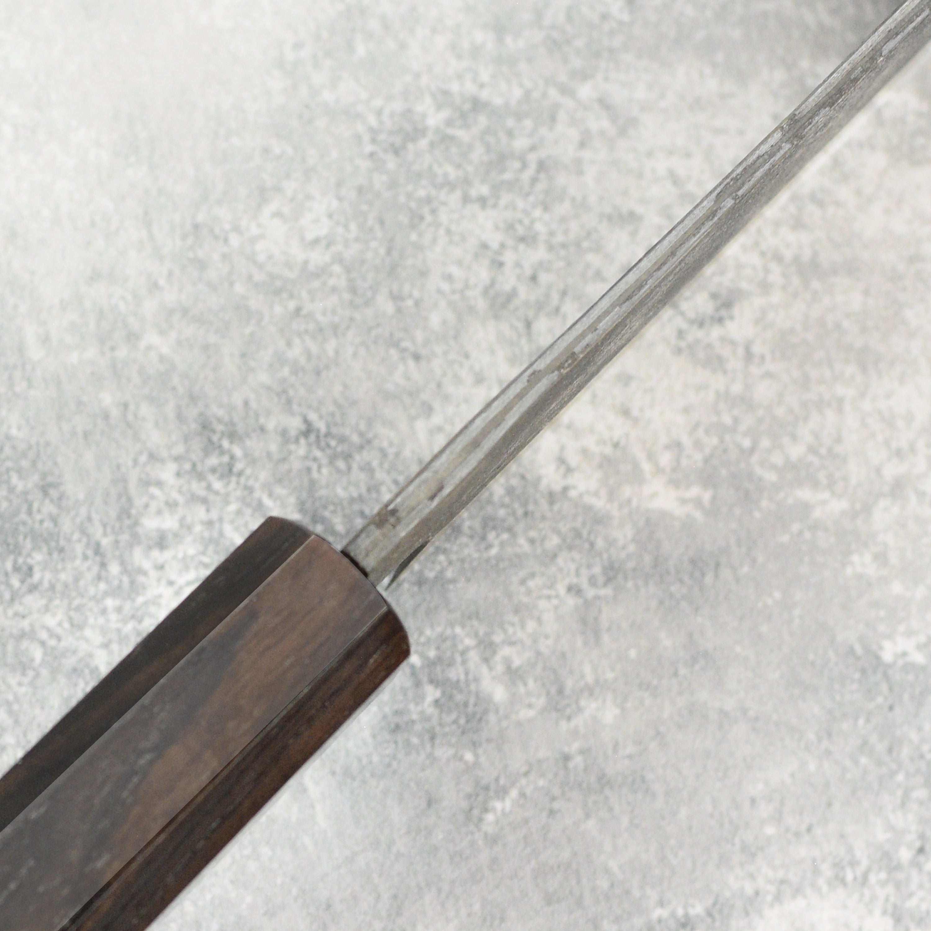 Hatsukokoro Santoku Knife in use, expertly slicing vegetables to demonstrate its precision and balance.