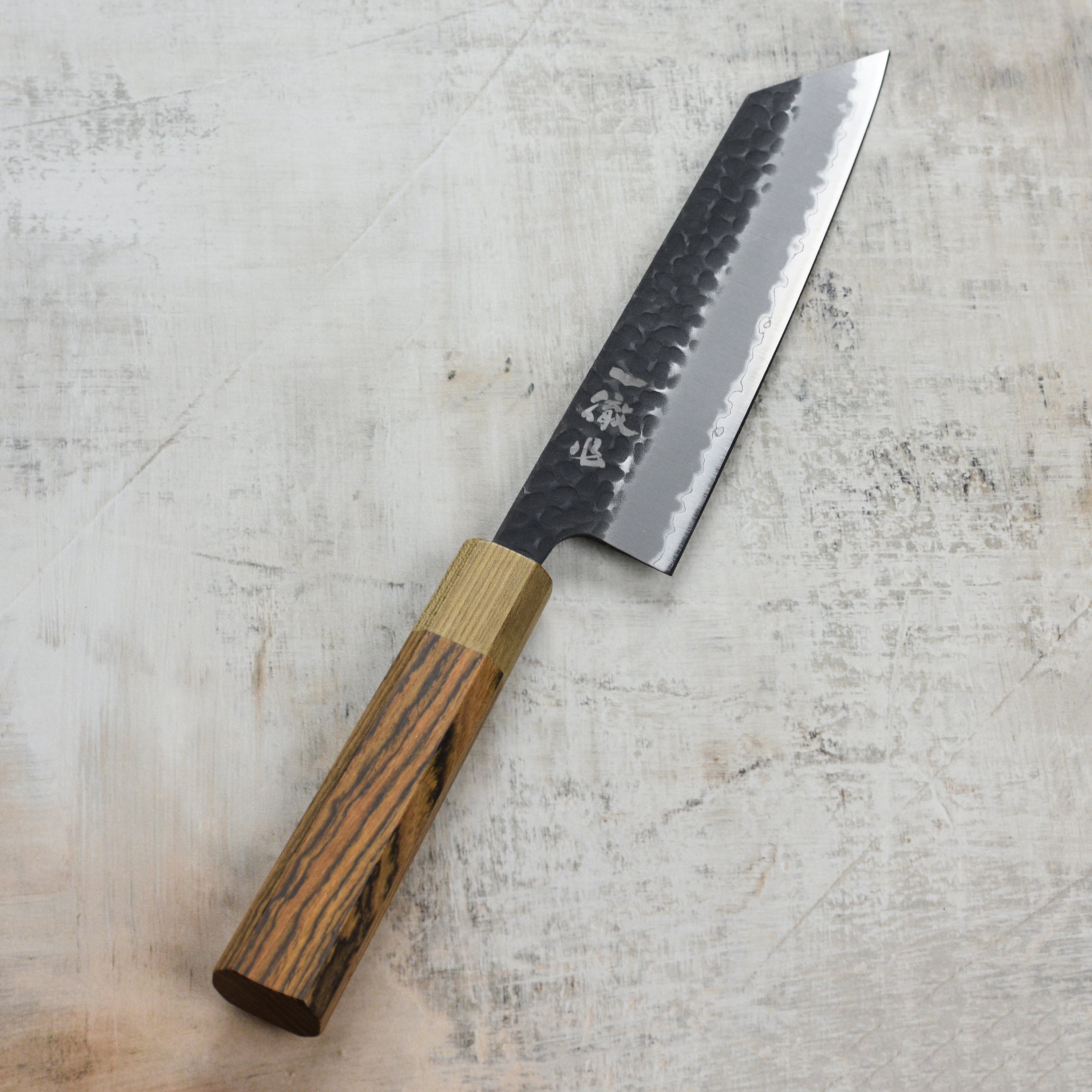 Ittetsu Aogami Bunka knife in use, effortlessly slicing through vegetables on a cutting board.