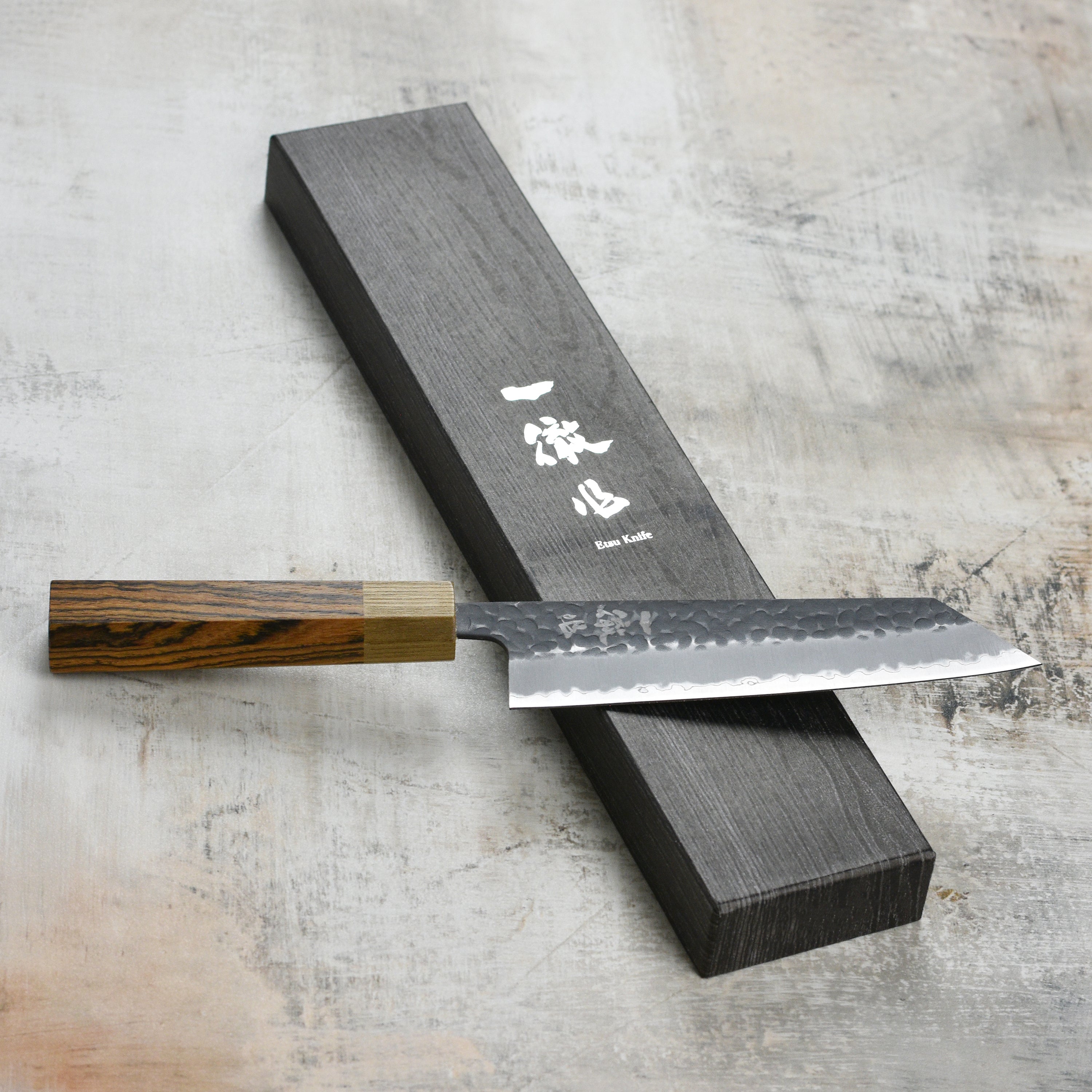 Ittetsu Aogami Super Kurouchi 6.7" Bunka Knife from a top angle, highlighting its sharp blade and grip.