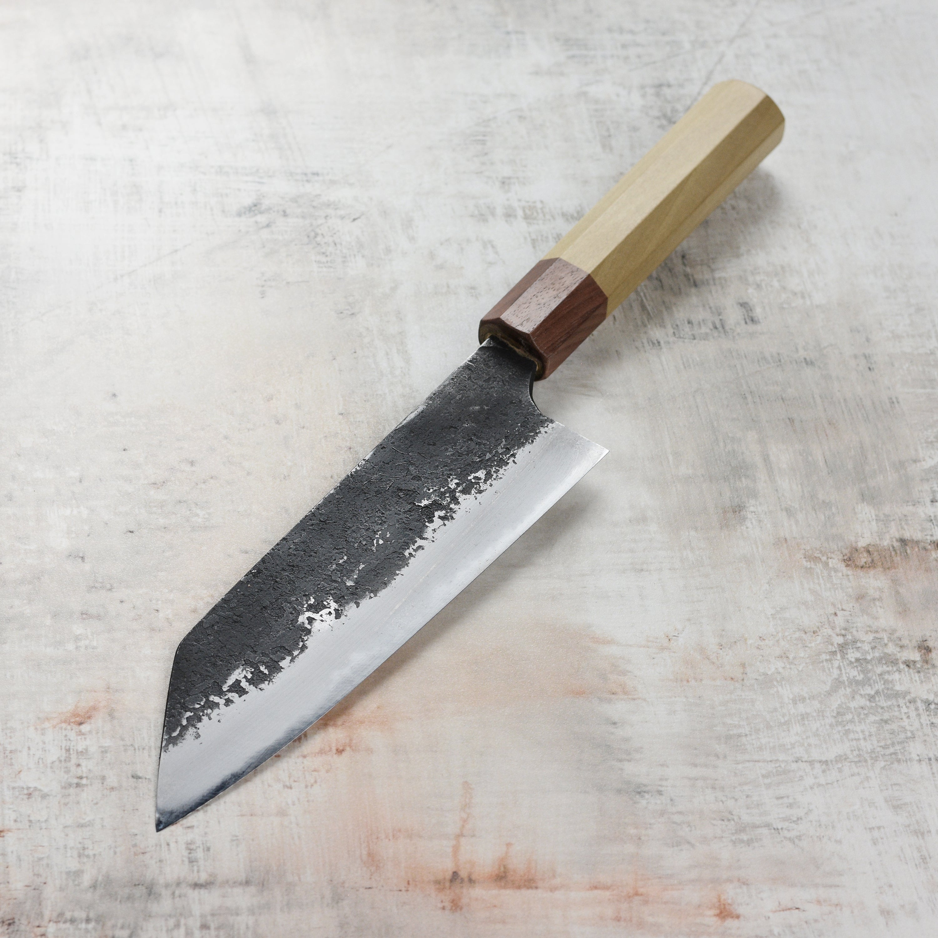 Close-up of the Kurouchi Nashiji finish on the Mazaki Shirogami Santoku knife, emphasizing its unique texture.