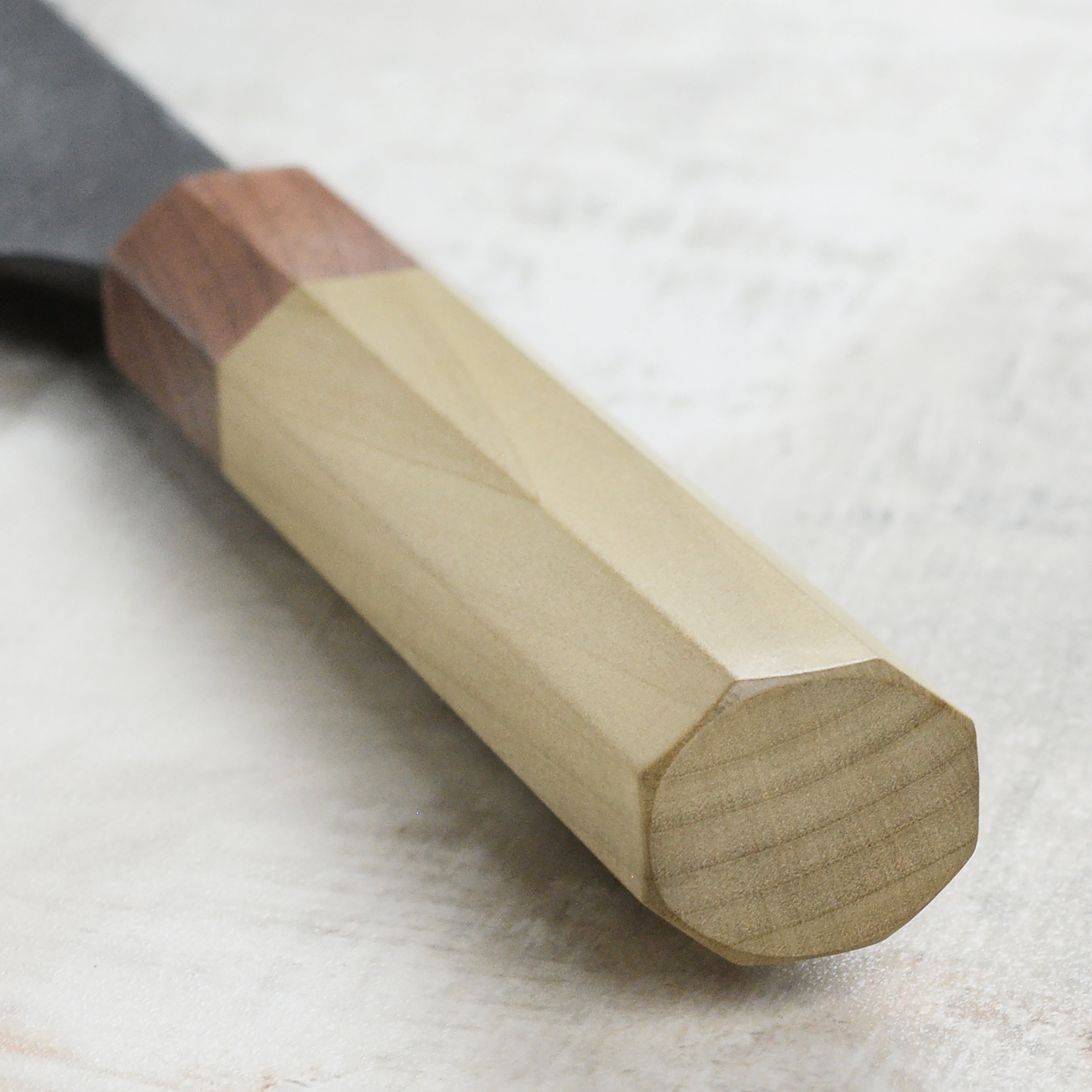 Close-up of the Kurouchi Nashiji finish on the Mazaki Shirogami Santoku knife, emphasizing its unique texture.