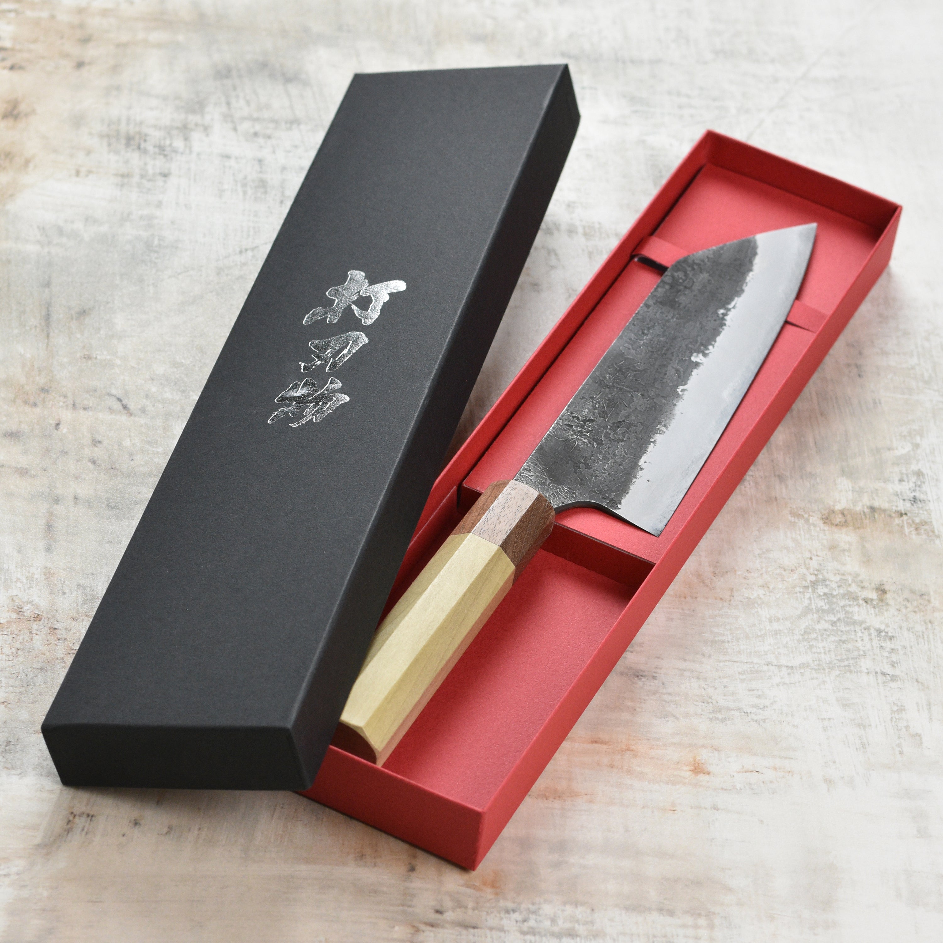 Close-up of the Kurouchi Nashiji finish on the Mazaki Shirogami Santoku knife, emphasizing its unique texture.