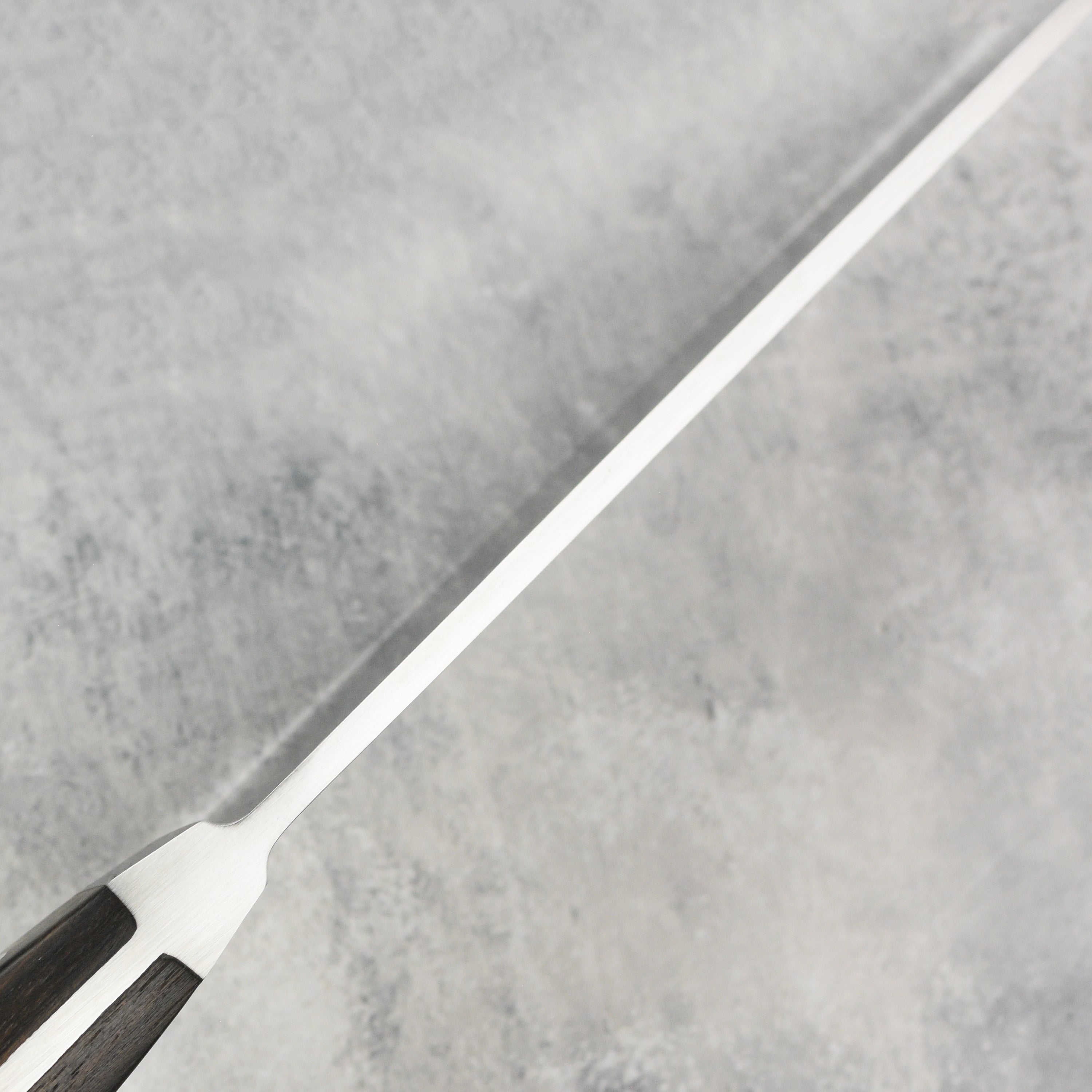 Close-up of the handle and bolster of the professional chefs knife