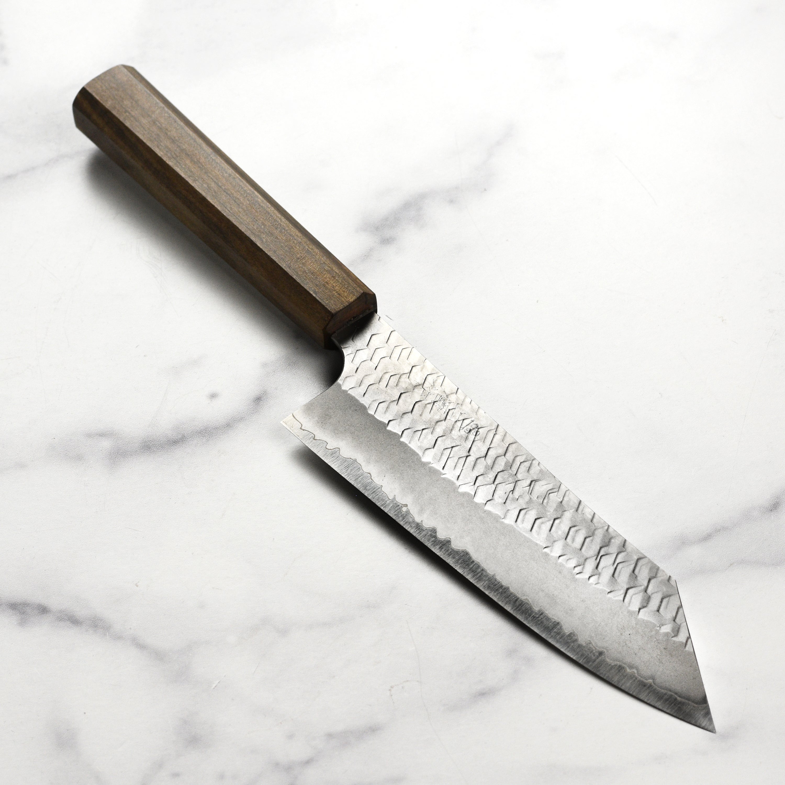 Nigara SG2 bunka knife with a detailed view of the hand-forged blade and tsuchime finish.