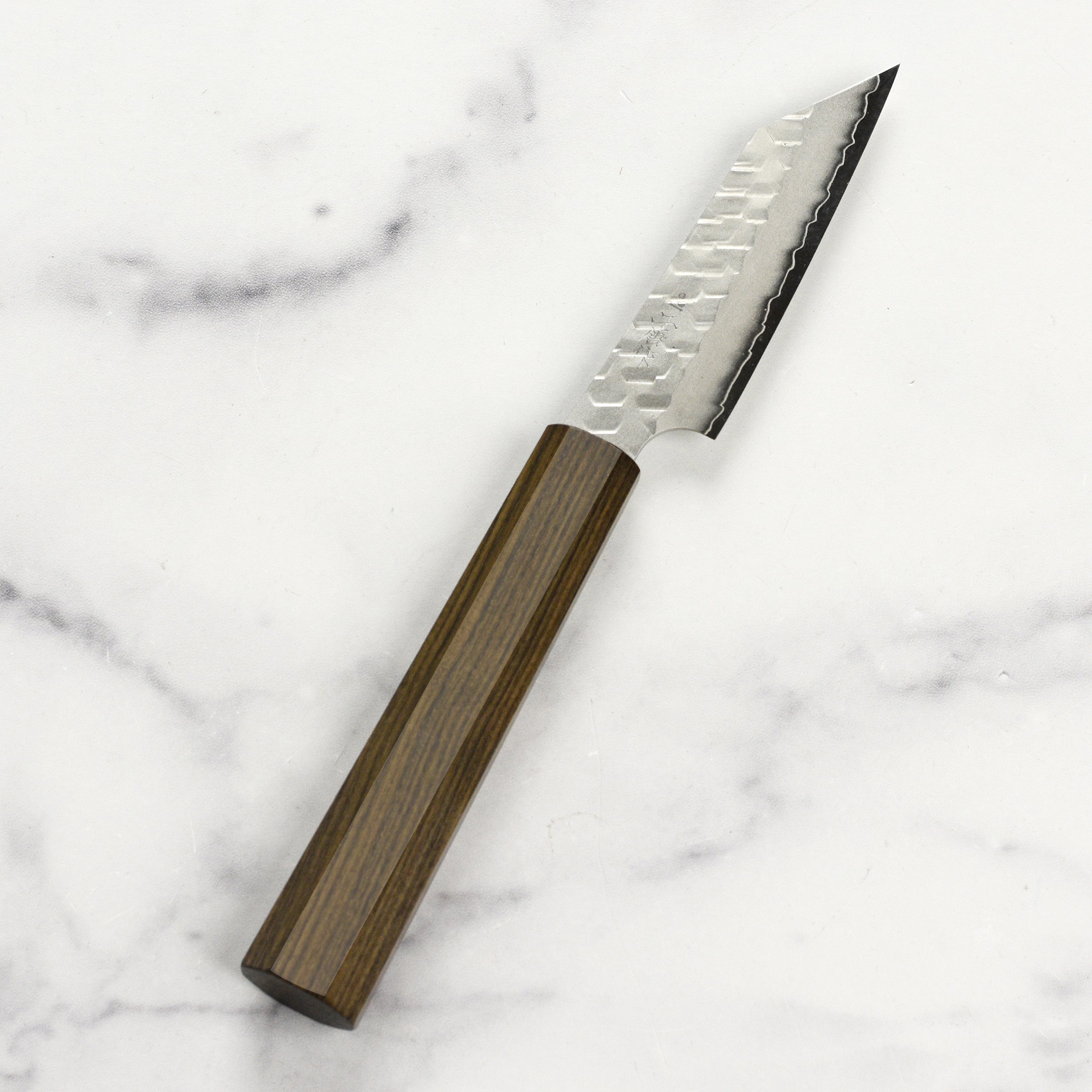 Close-up of the Nigara SG2 Migaki Tsuchime Kiritsuke Petty Knife in use for precision chopping