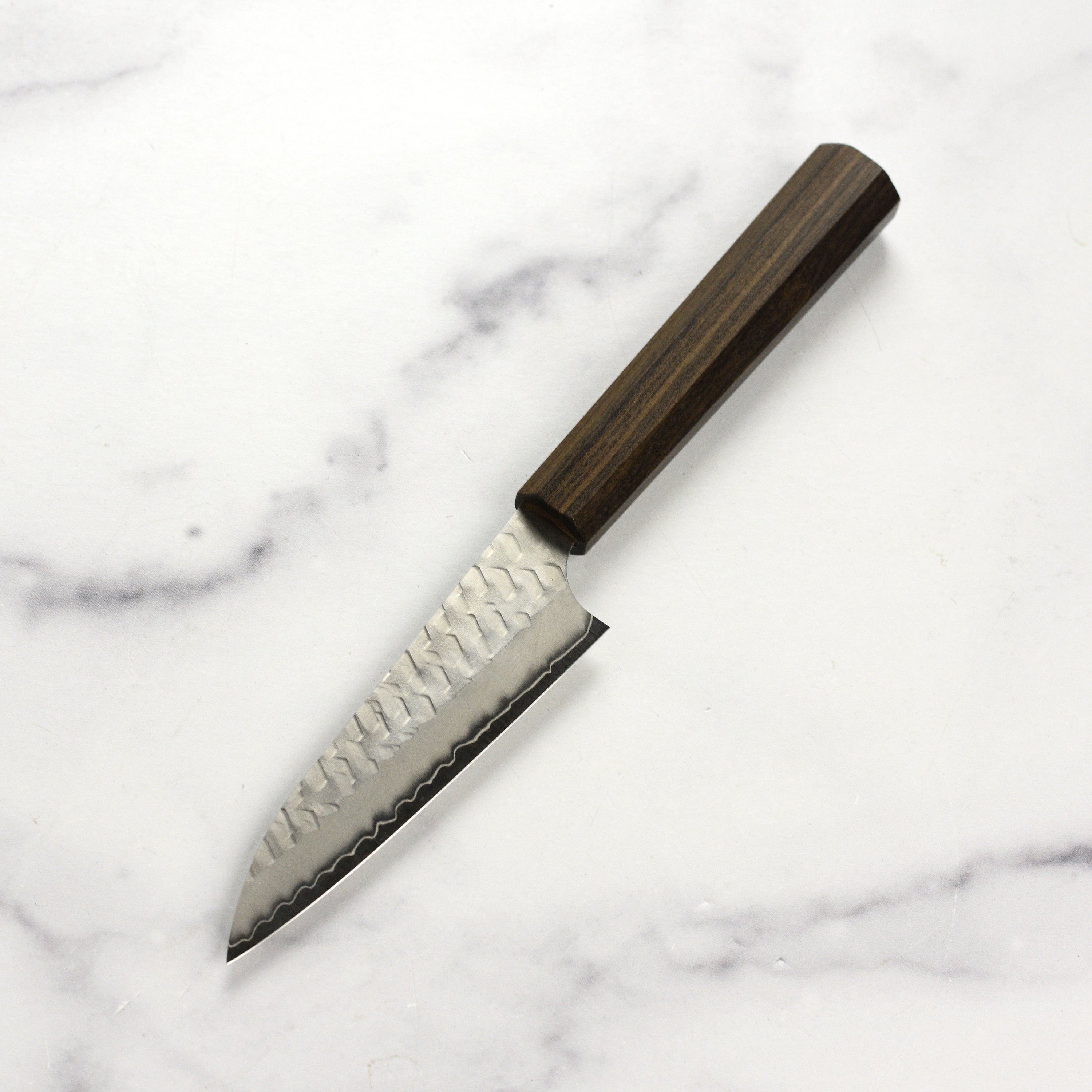 Chef using the Japanese petty knife to prepare vegetables