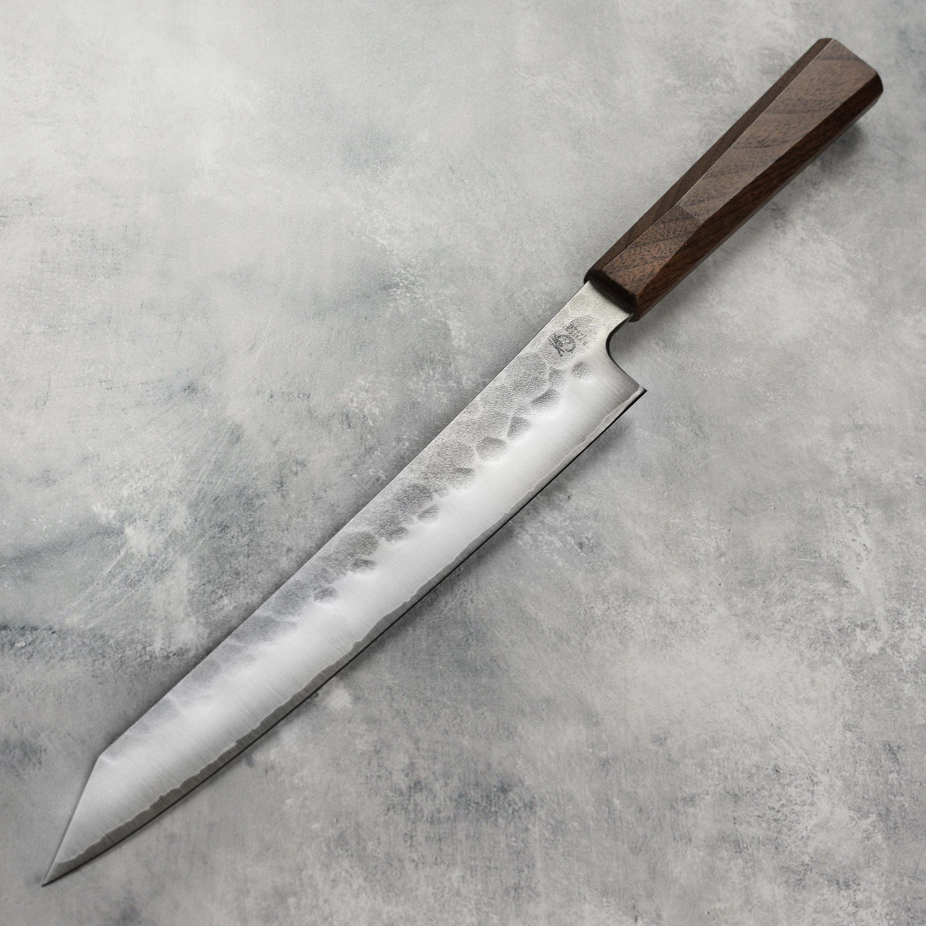 Close-up of the sharp edge of the professional kitchen knife made from SG2 steel