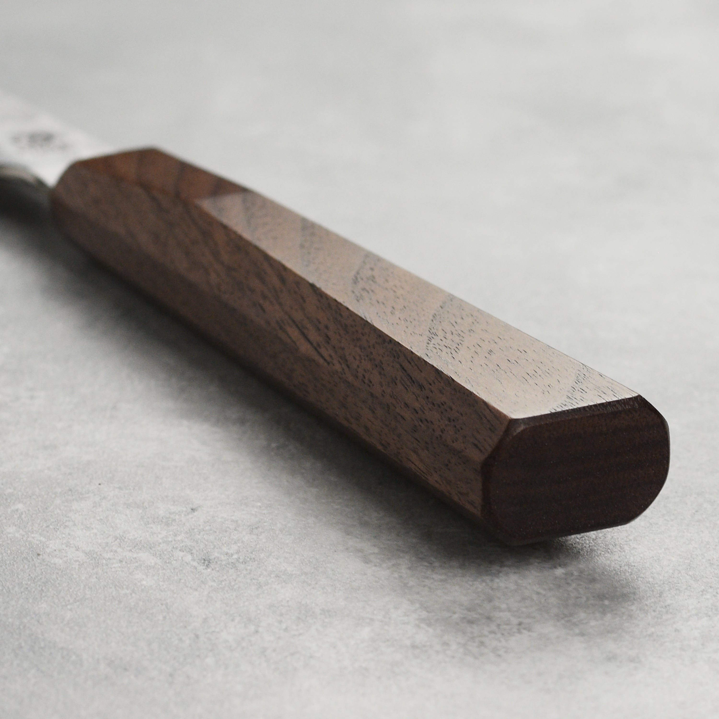 Close-up of the sharp edge of the professional kitchen knife made from SG2 steel