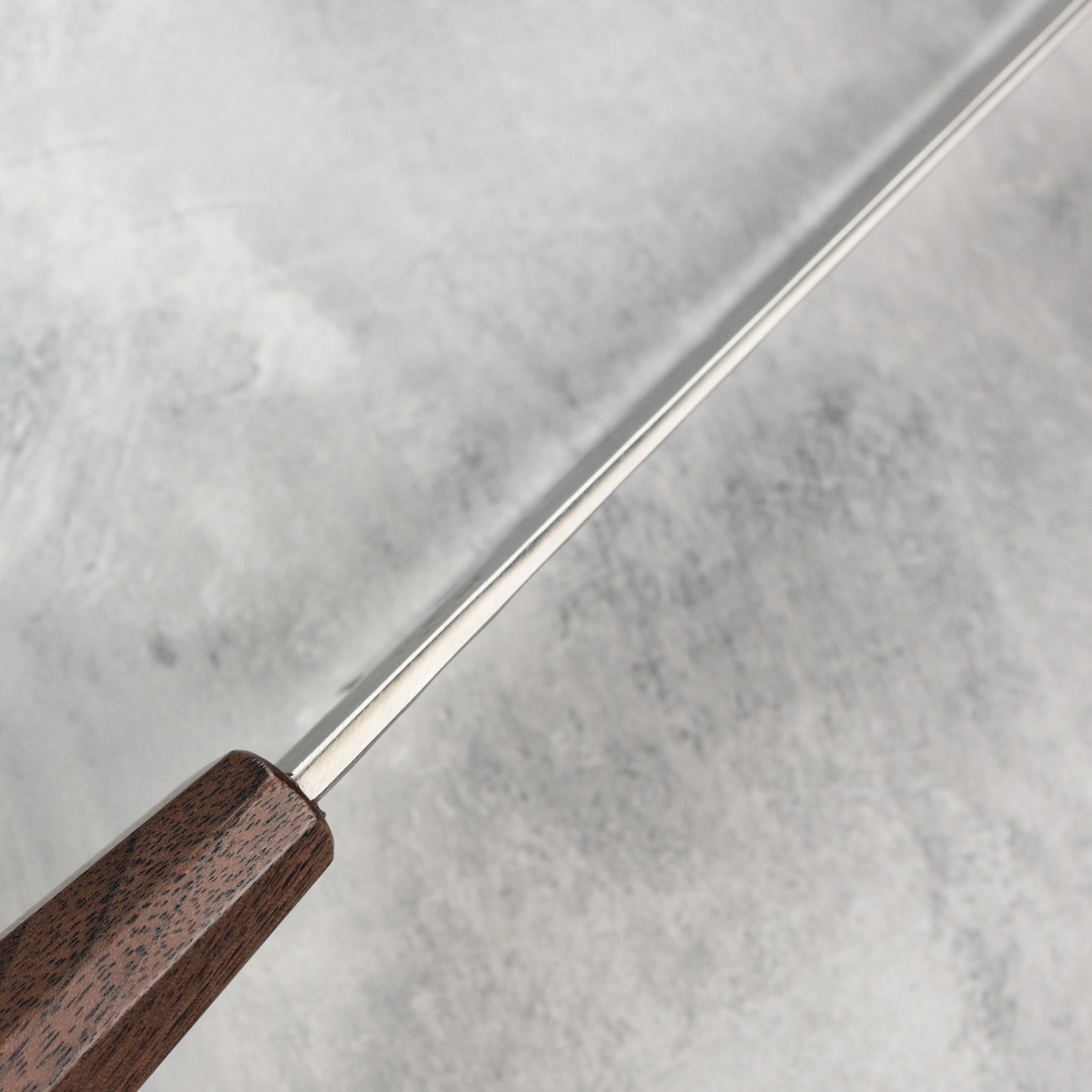 Elegant handle of the Japanese slicing knife with detailed craftsmanship for comfortable grip