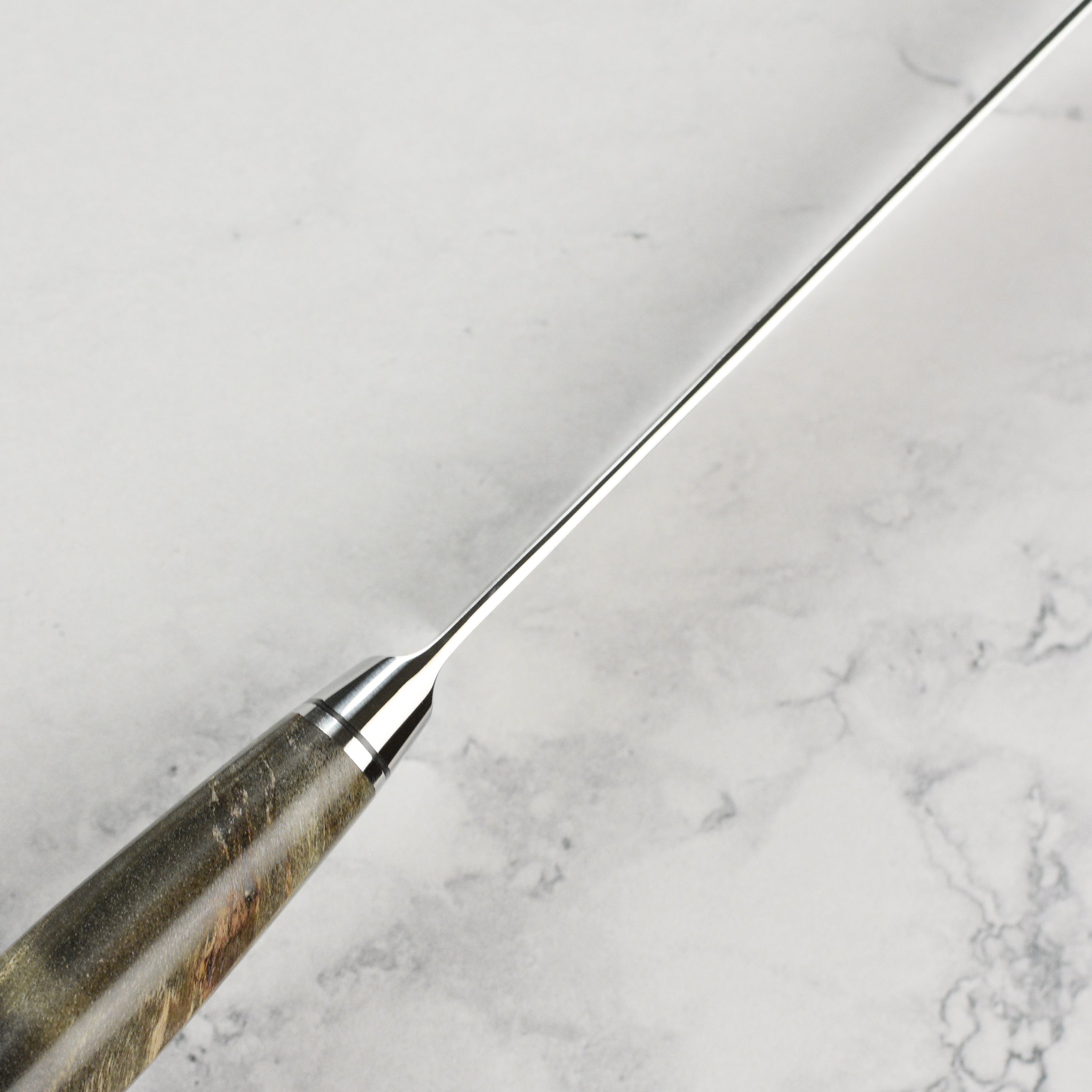 Chef using the Ryusen petty knife for precise slicing on a cutting board