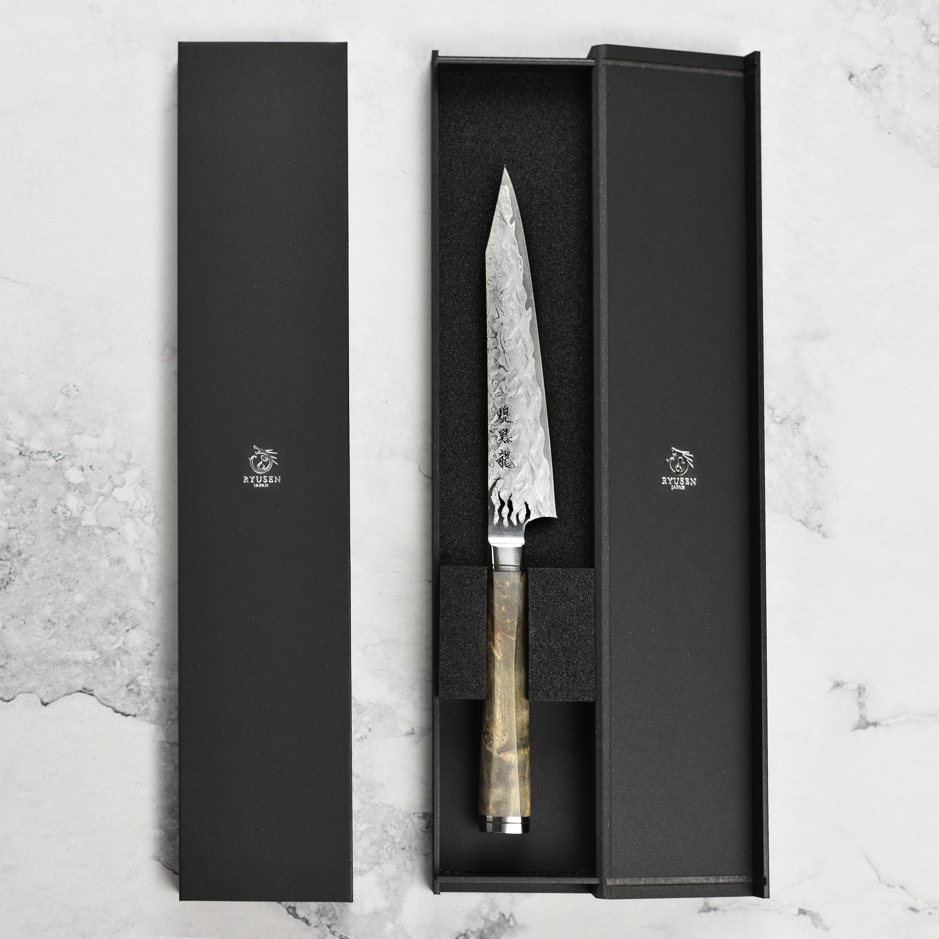 Chef using the Ryusen petty knife for precise slicing on a cutting board