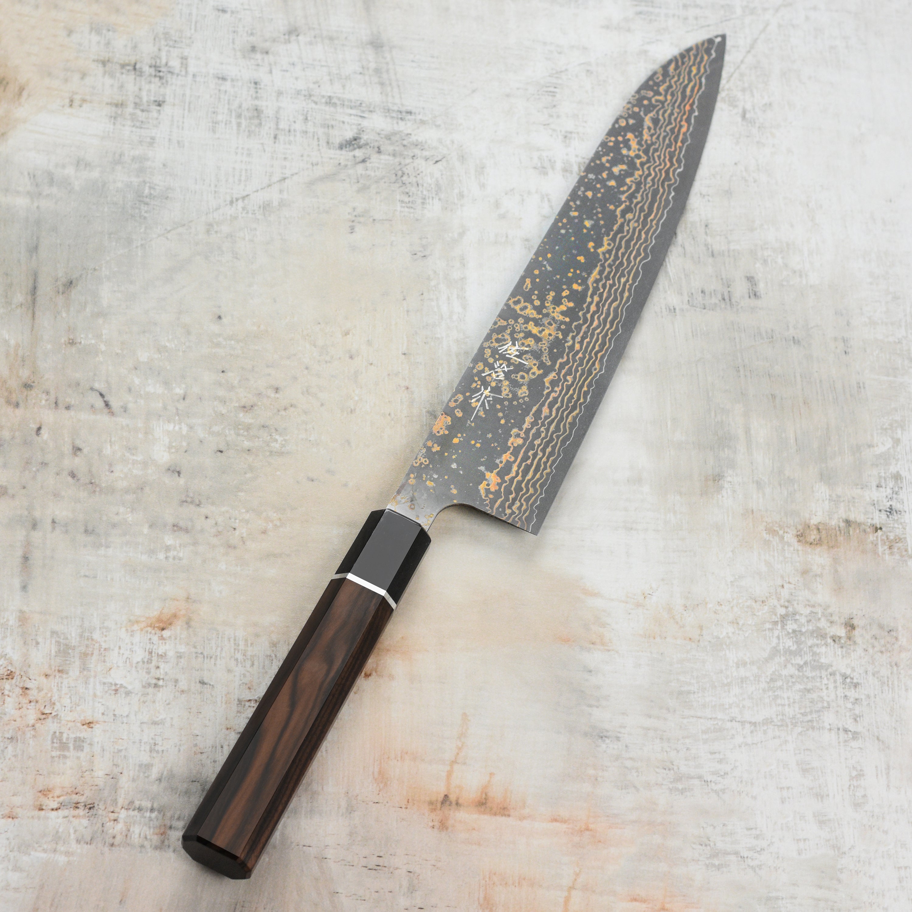 Japanese handcrafted gyuto knife with ebony handle and Damascus steel finish