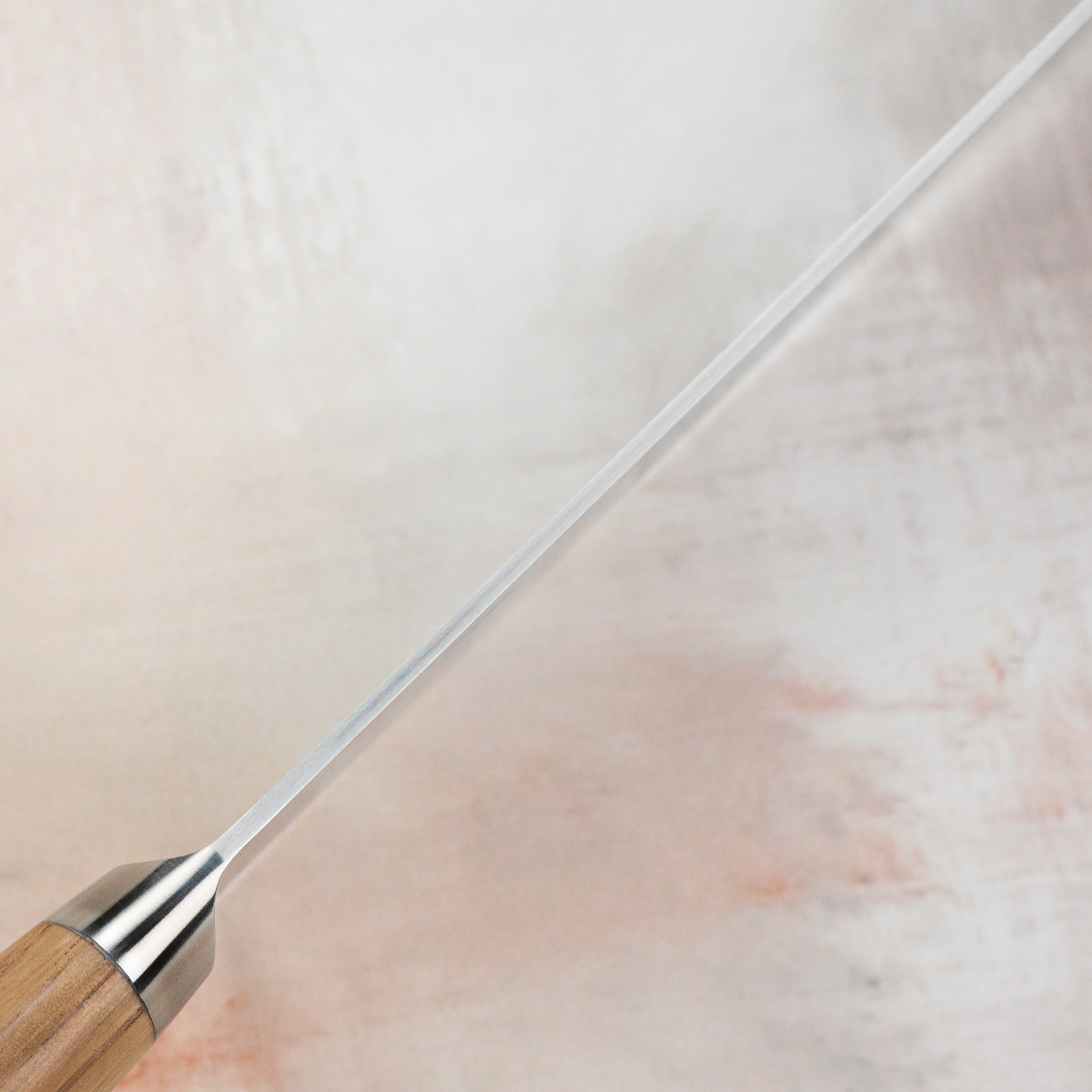 Detailed shot of the high-carbon Japanese steel blade of the Santoku knife