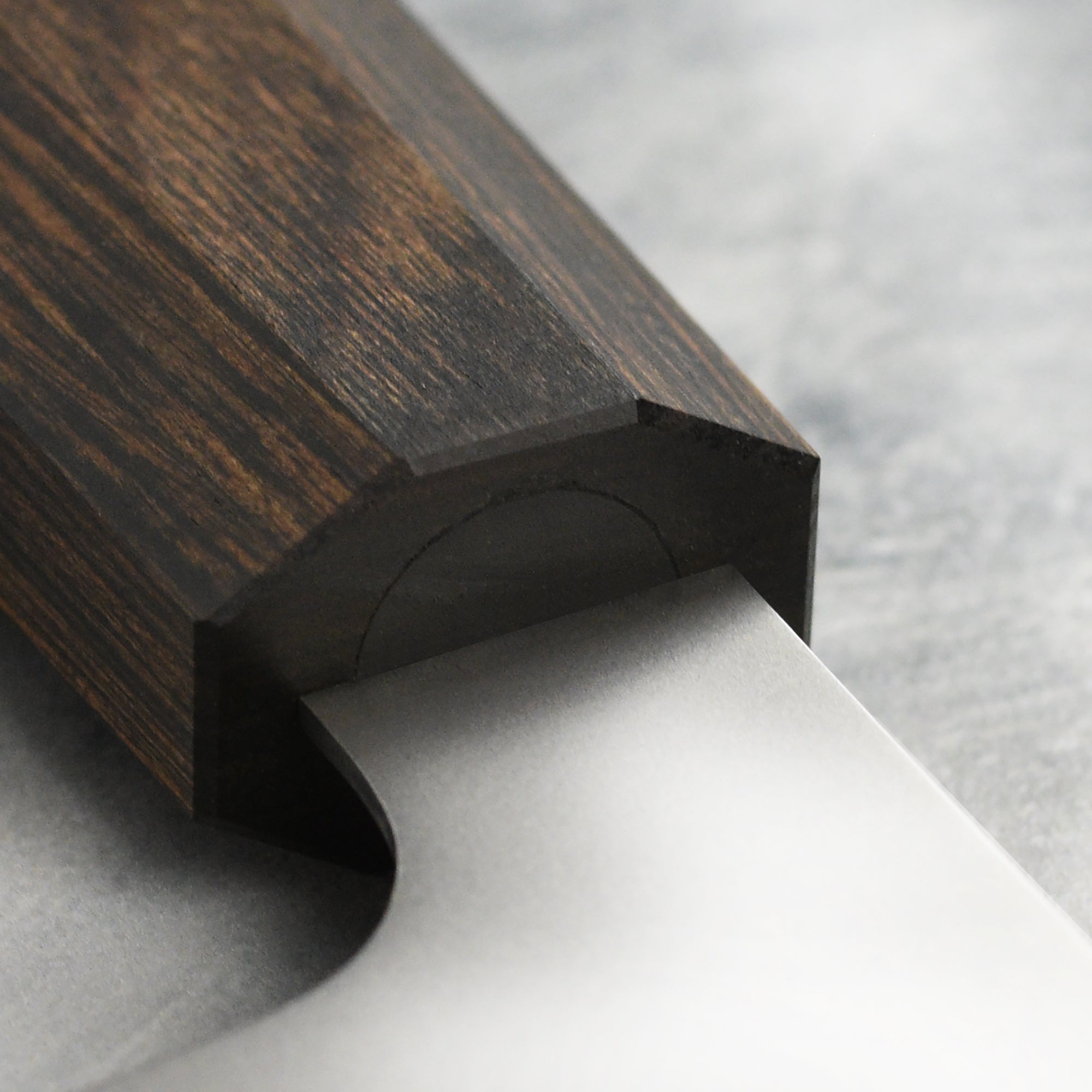Close-up of Yaxell Hana petty knifes ergonomic handle, designed for comfort and control during use.