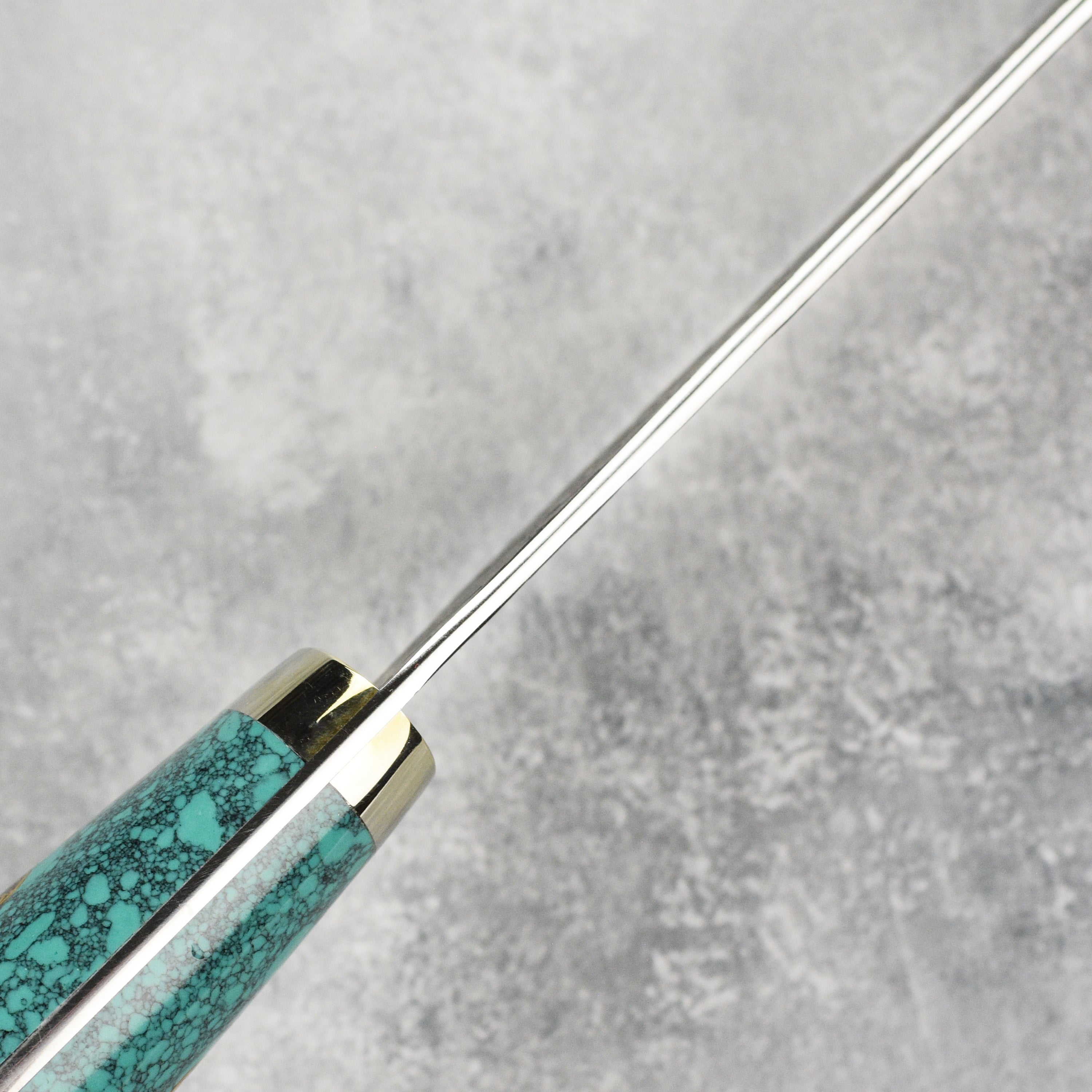 Nigara SG2 Kurouchi Sujihiki displayed on a wooden cutting board, perfect for any kitchen setting.