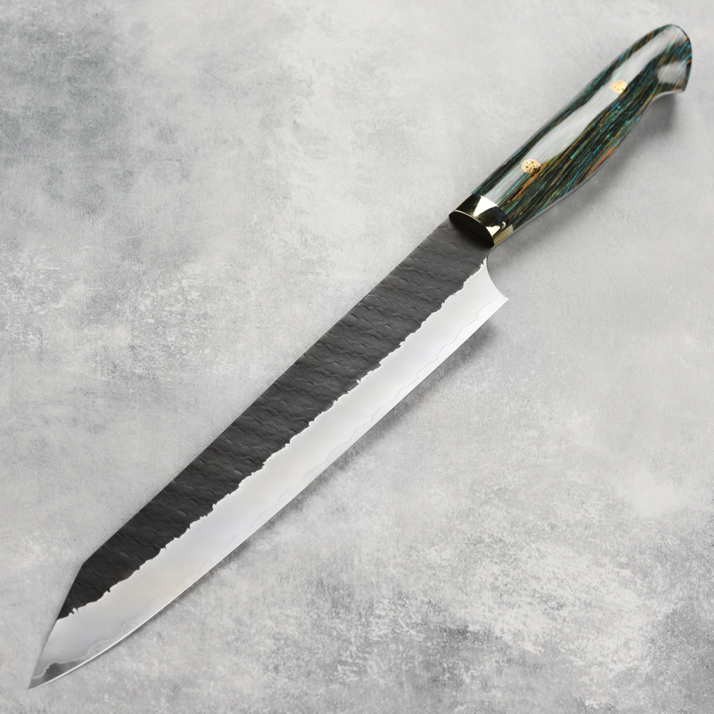Stylish striped turquoise handle of the kiritsuke knife, emphasizing its craftsmanship and aesthetic appeal