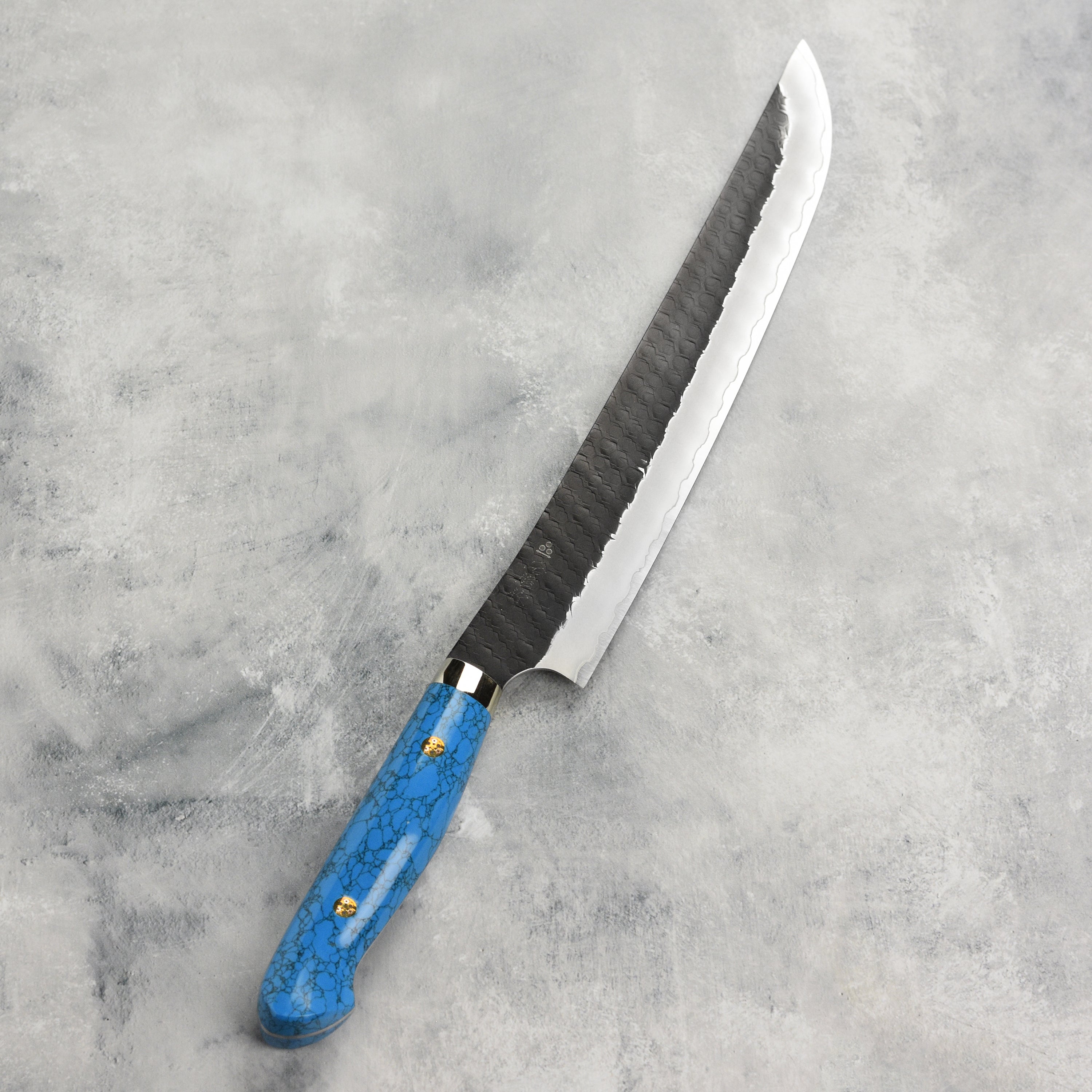 Chef slicing fish with the Nigara Japanese sujihiki knife in a professional kitchen