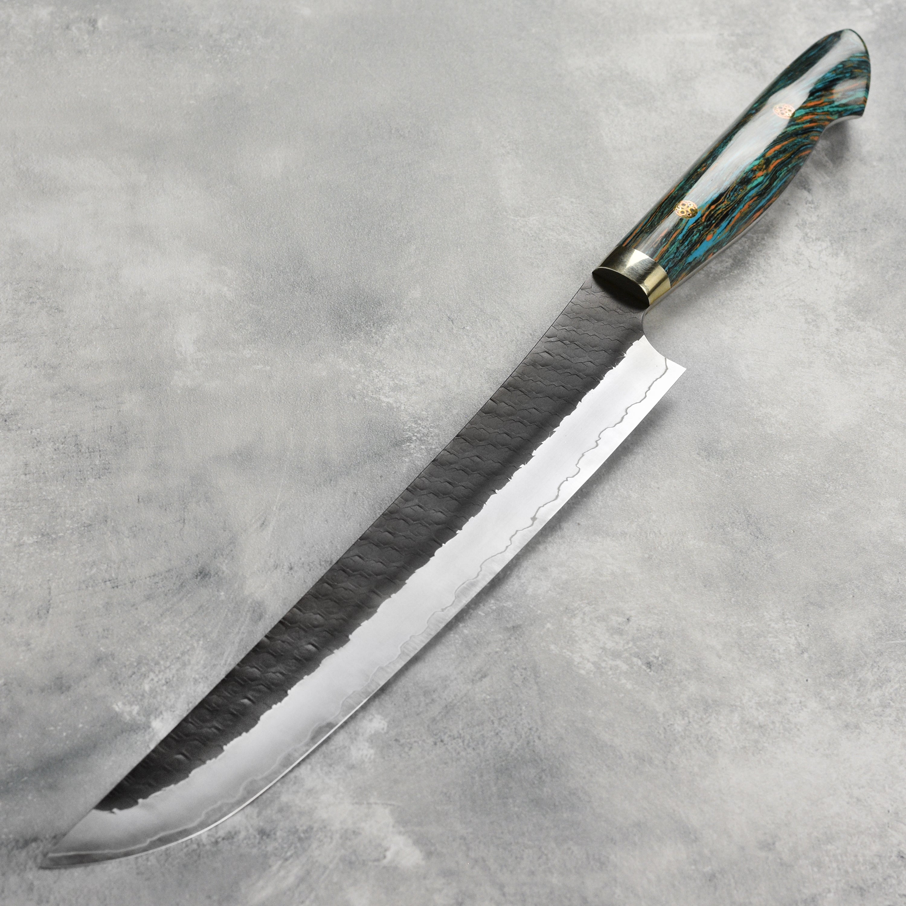 Chef using the sujihiki knife to slice fish, demonstrating its precision and balance.
