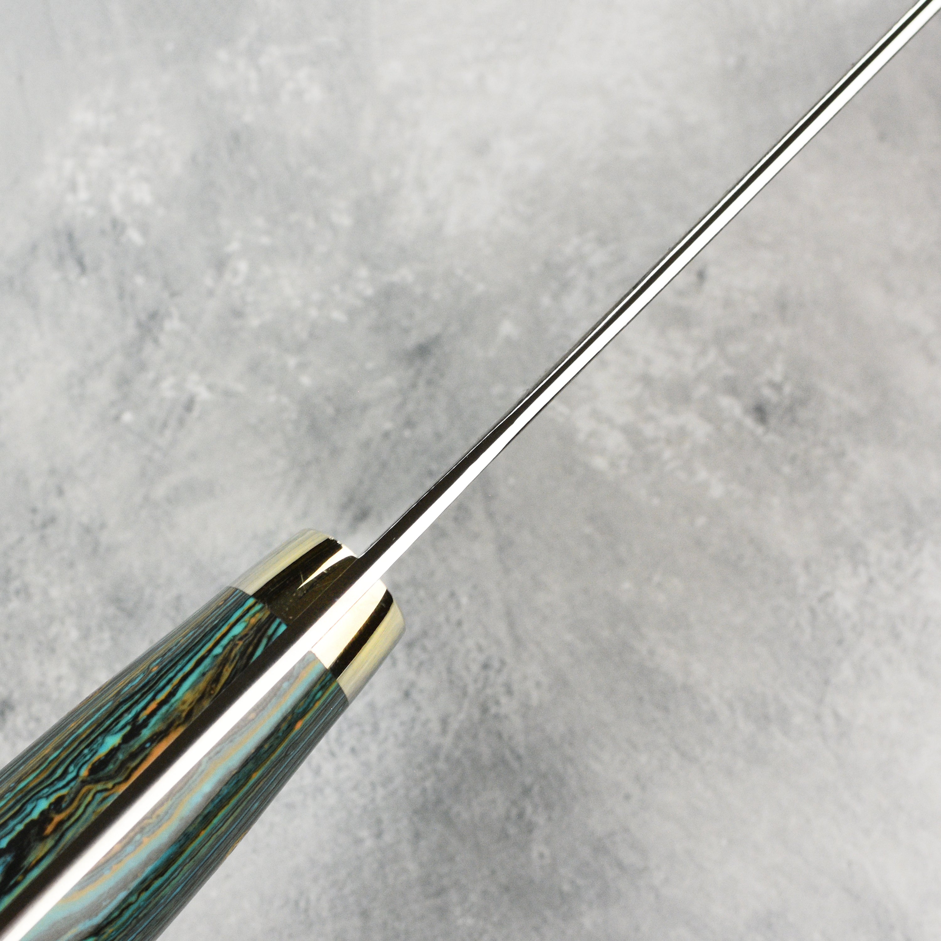 A beautifully displayed 7-inch kiritsuke knife alongside fresh ingredients, highlighting its elegance.