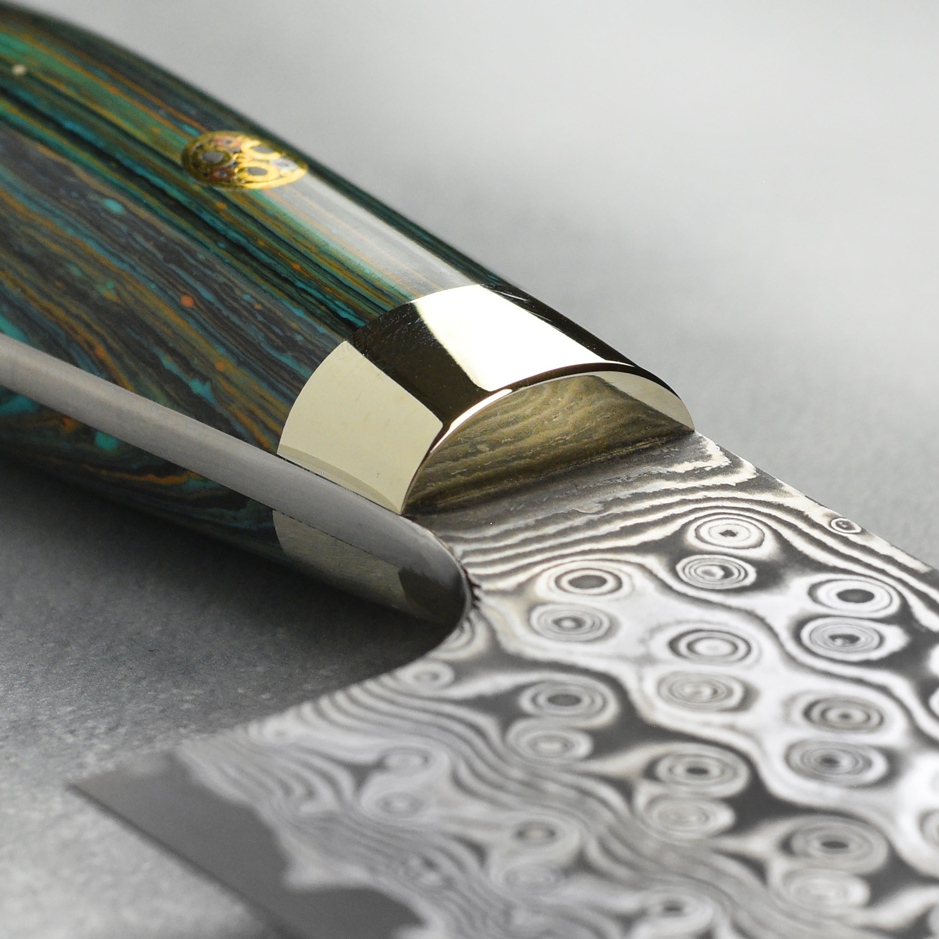 The Damascus knife in action, expertly slicing vegetables on a wooden cutting board.