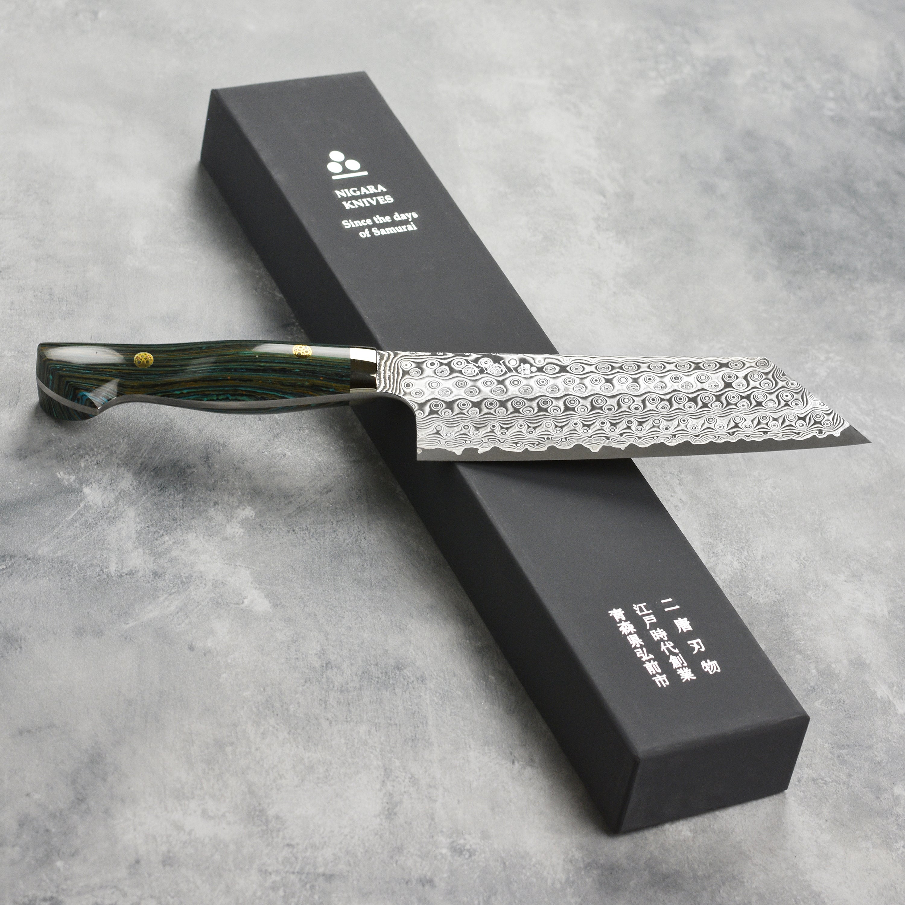 A beautifully displayed 7-inch kiritsuke knife alongside fresh ingredients, highlighting its elegance.