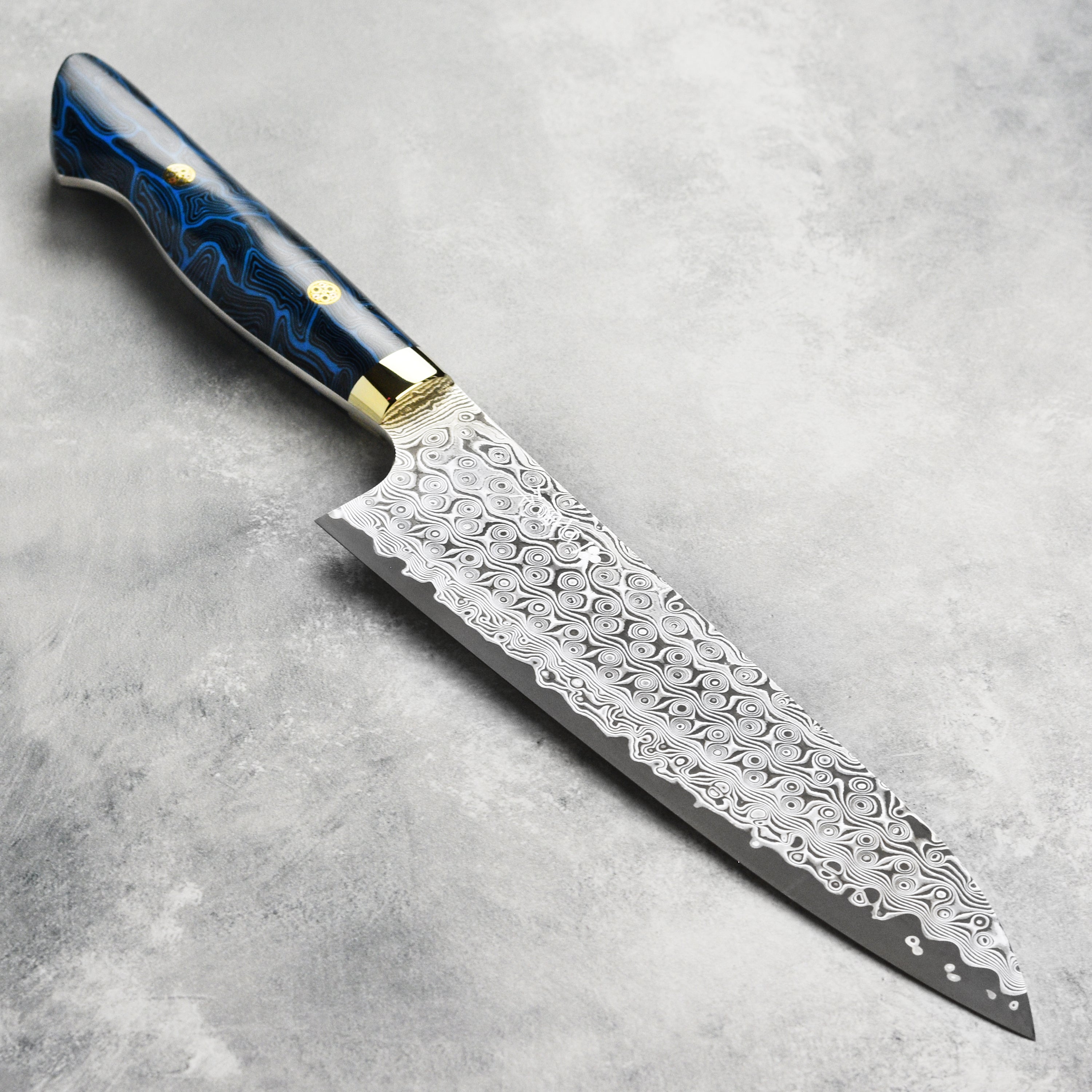 Top view of Nigara Anmon SG2 Damascus gyuto knife with G10 handle for precise slicing