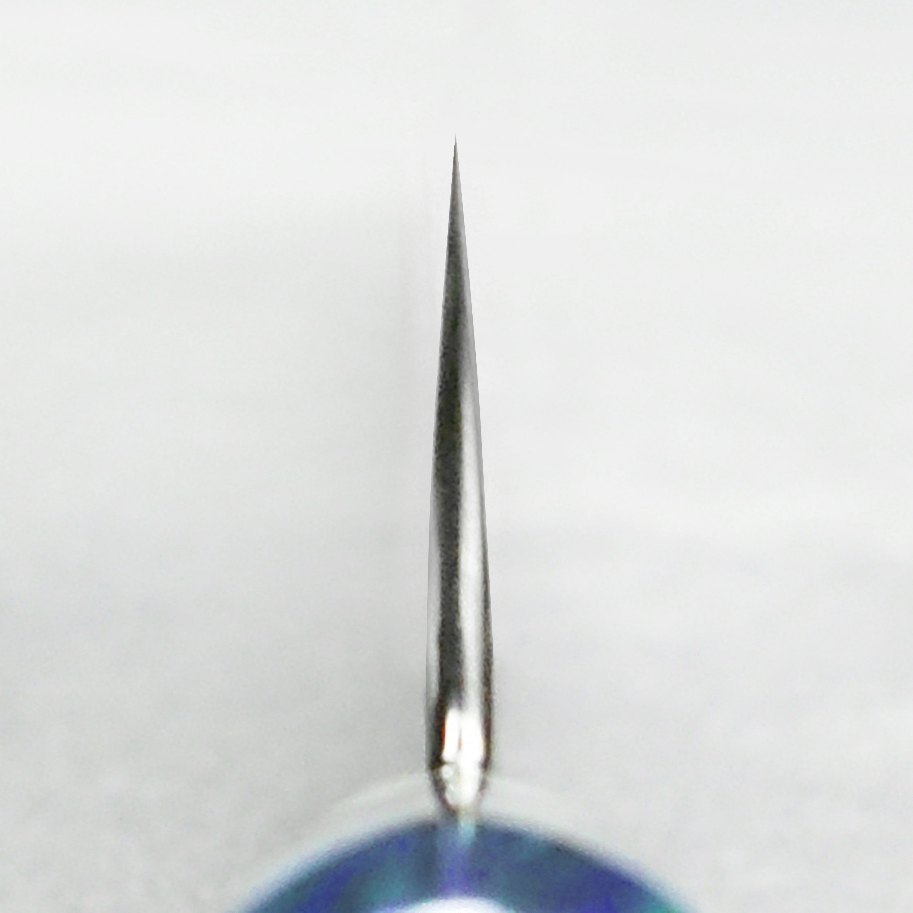 Close-up of the Damascus pattern and sharp edge of the gyuto knife